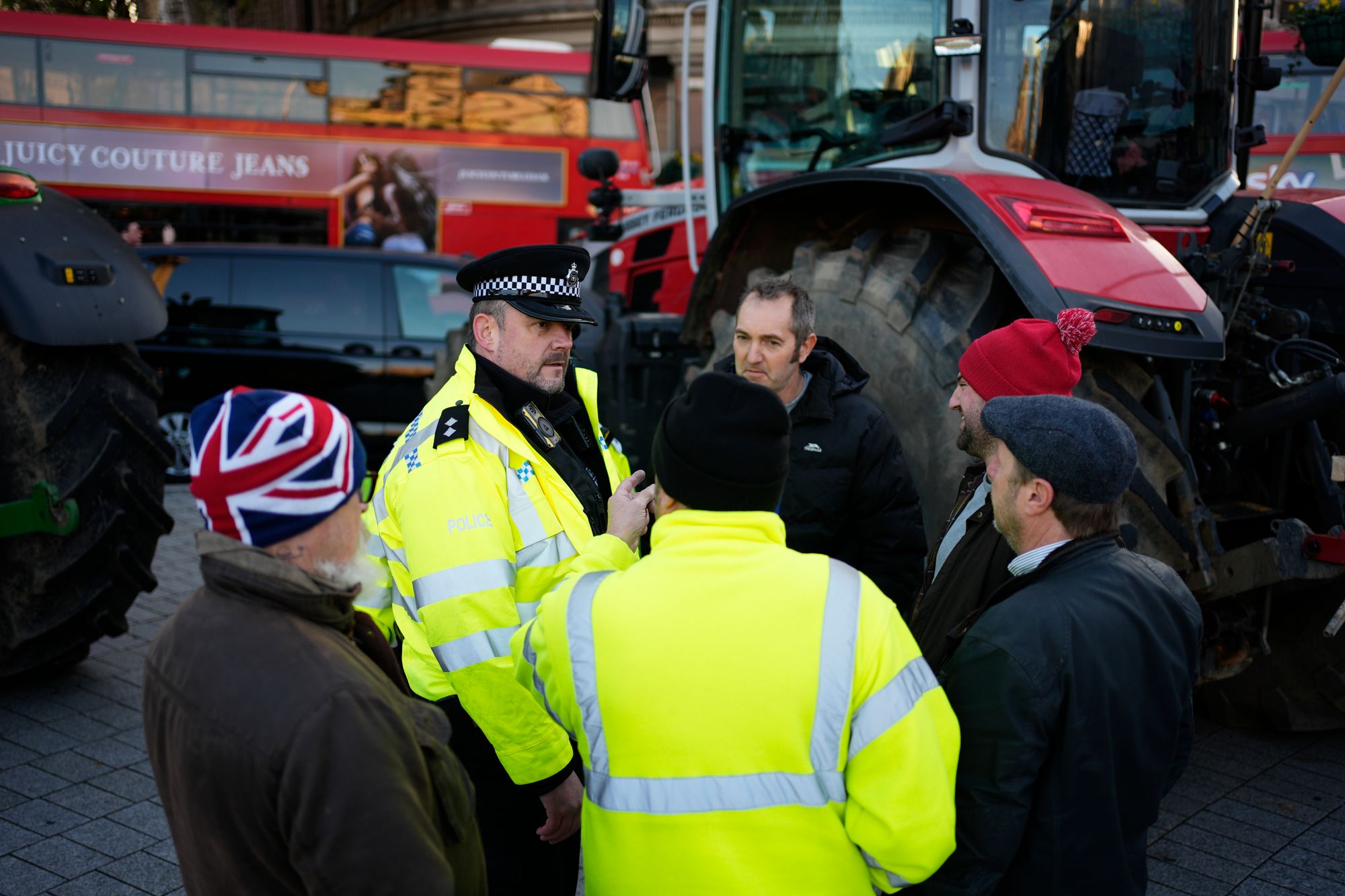 Police officers speak to farmers taking part in a protest with their tractors in Westminster, London, ahead of Rachel Reeves Budget