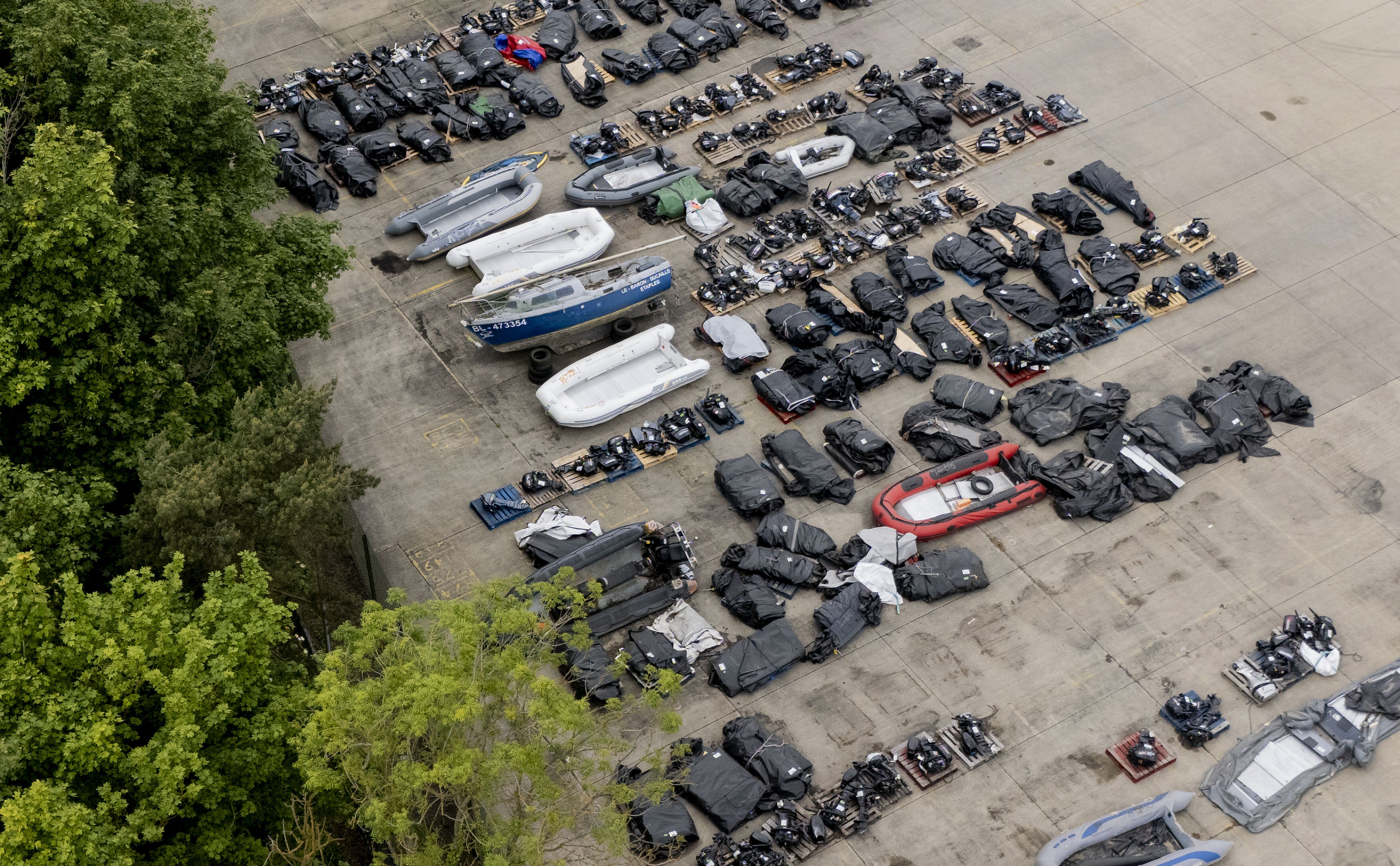 A view of small boats and outboard motors used by people thought to be migrants to cross the Channel from France at a warehouse facility in Dover, Kent. Small boat arrivals are up 53 per cent year on year