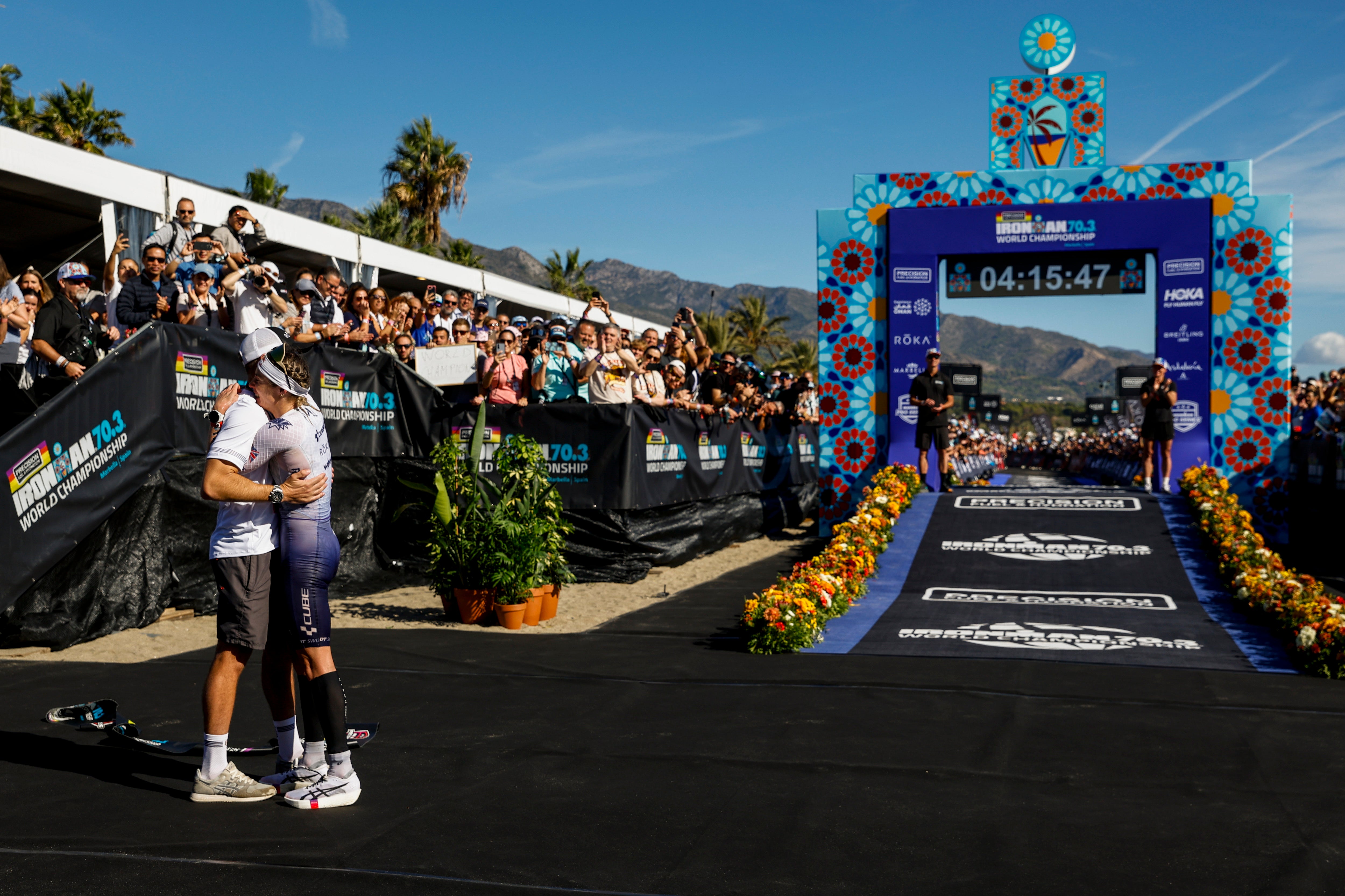 Charles-Barclay hugs husband Reece after victory in Marbella