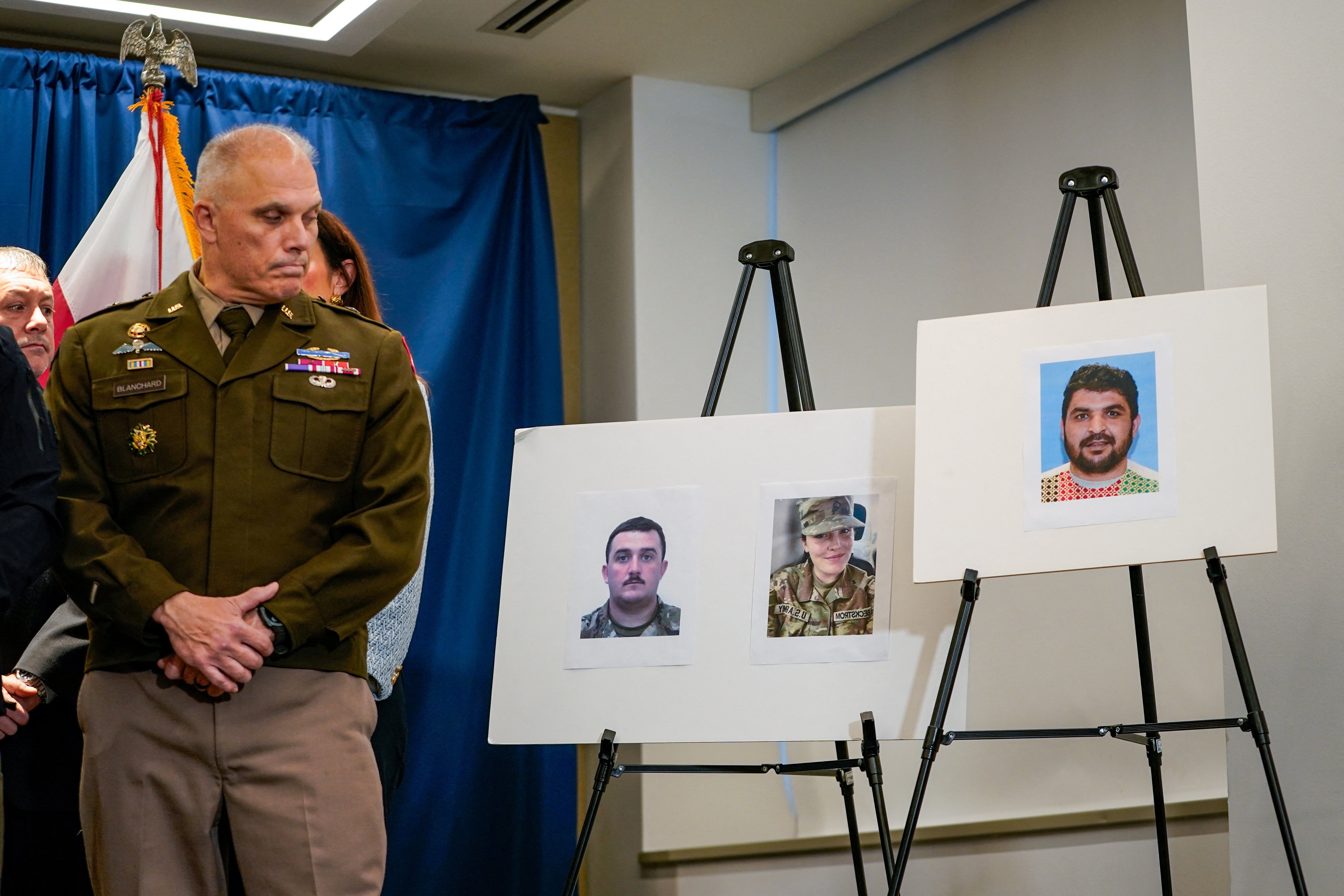 Brigadier General Leland D. Blanchard II looks towards pictures of two National Guard members who were shot in Washington on November 26, along with a picture of a suspect, Afghan national Rahmanullah Lakanwal, at a press conference with FBI Director Kash Patel, attorney Jeanine Pirro and other authorities in Washington, D.C., U.S., November 27, 2025. REUTERS/Nathan Howard