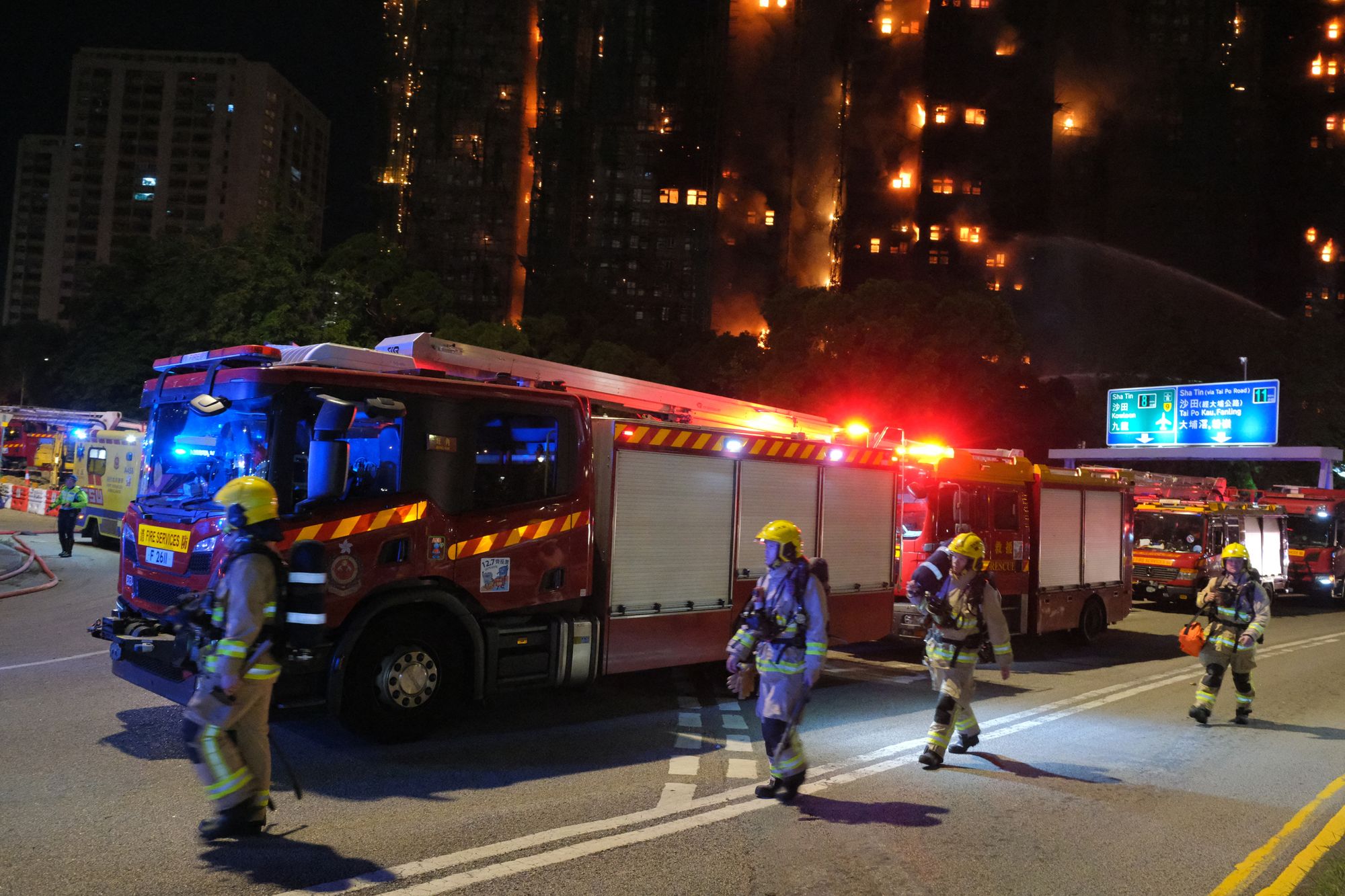 Firefighters work at the scene as a major fire engulfs several apartment blocks at the Wang Fuk Court residential estate in Hong Kong's Tai Po district