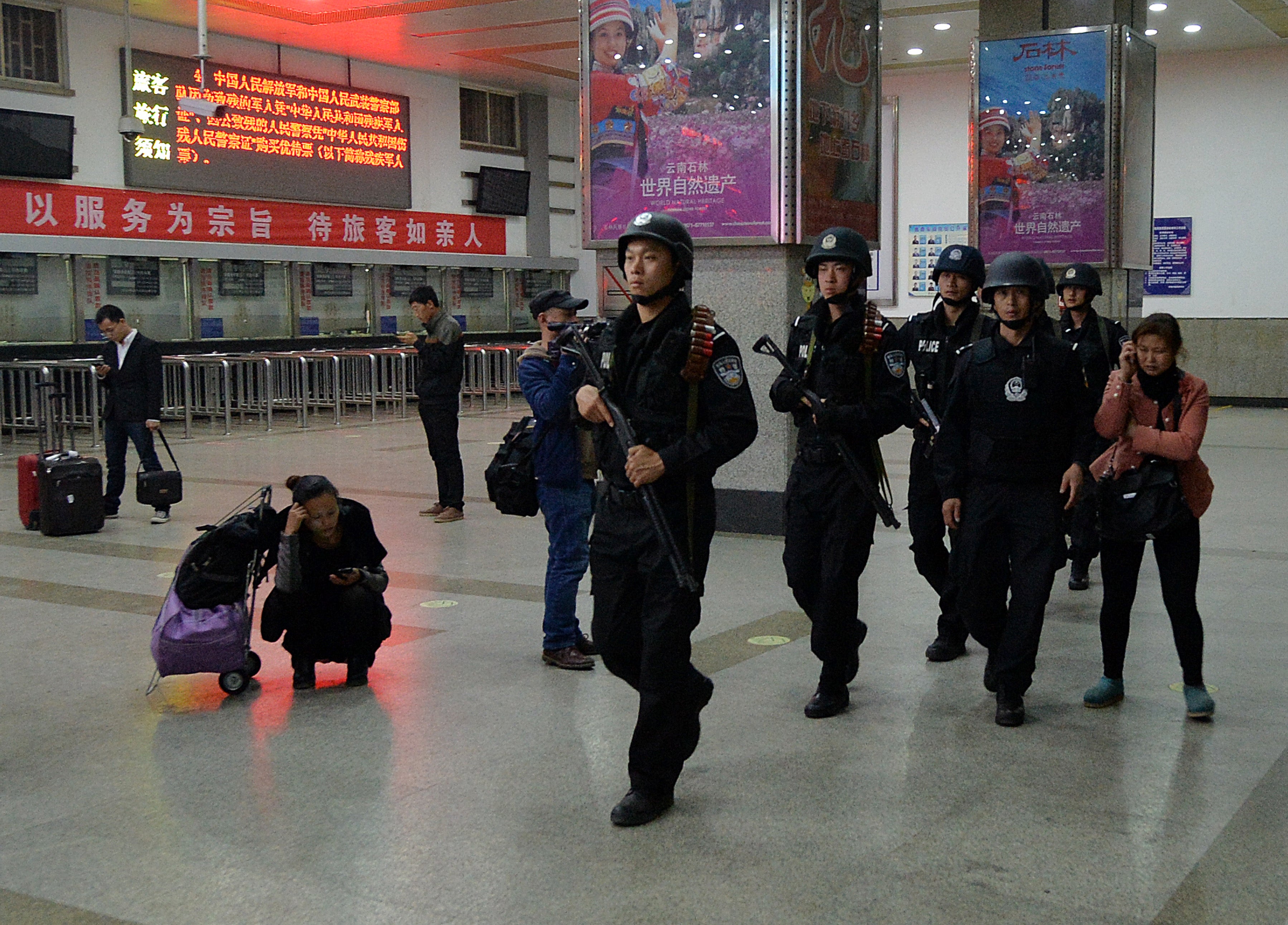 File: Chinese armed police patrol the scene of the terror attack at the main train station in Kunming, Yunnan Province on March 2, 2014