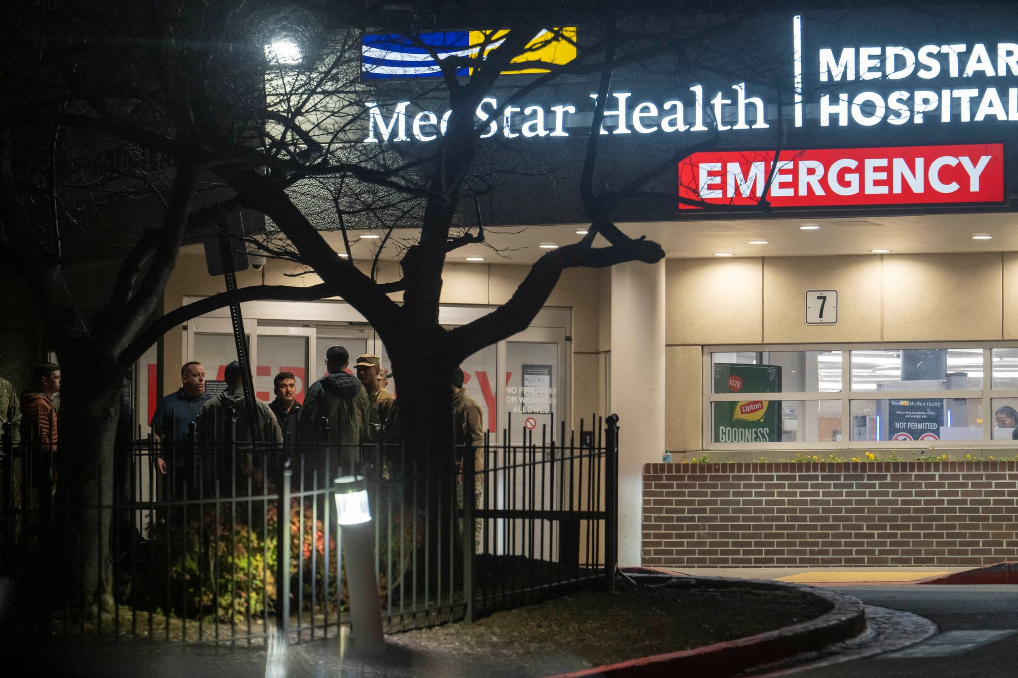 National Guard members and other personnel stand outside of the MedStar Washington Hospital Center after the death of West Virginia National Guard member Sarah Beckstrom