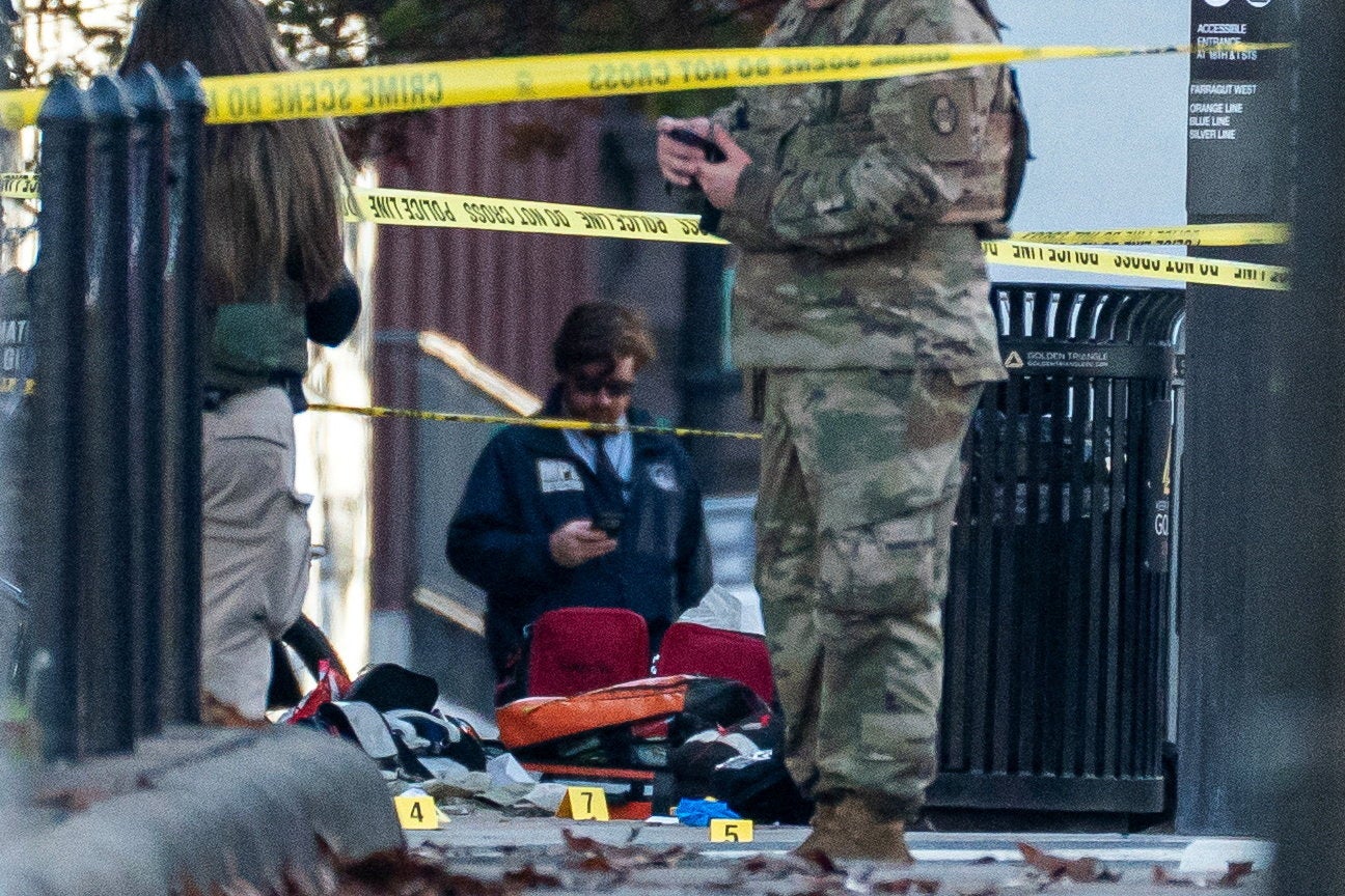 Evidence markers sit on the ground after two National Guard members were shot near the White House