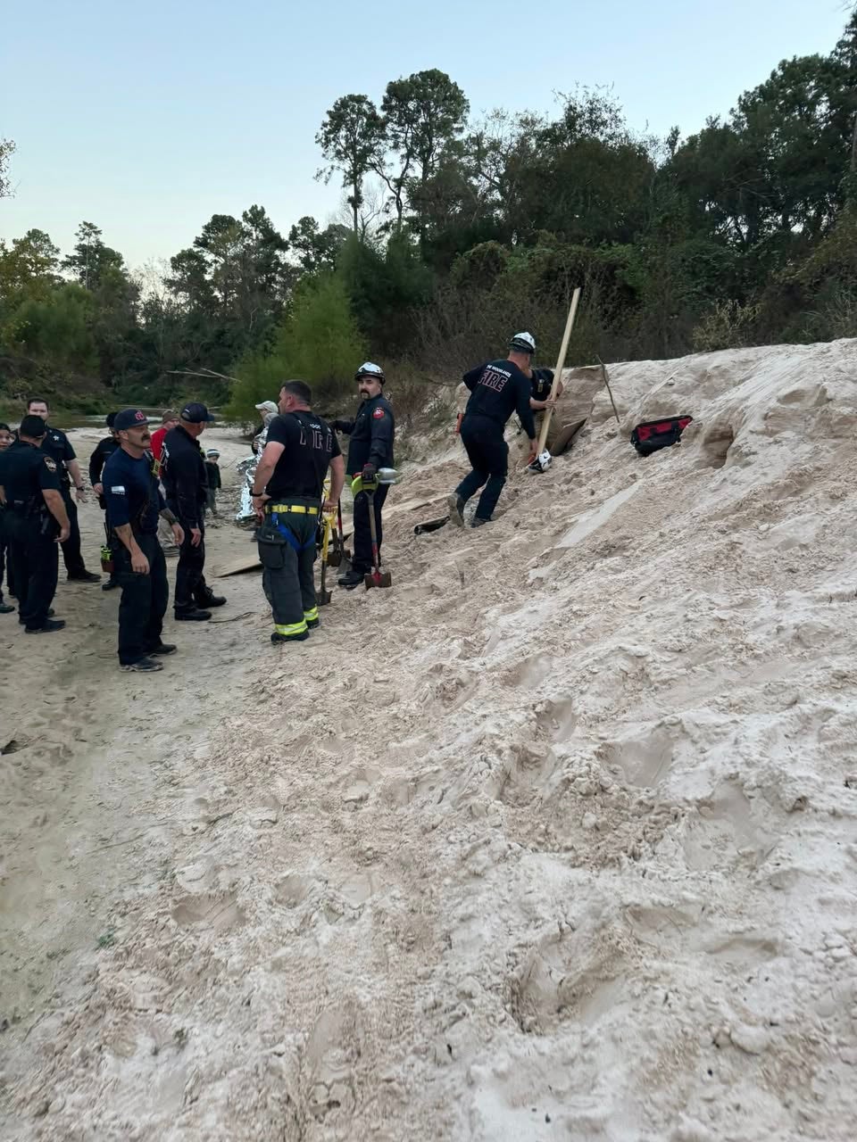 First responders at the scene after a 12-year-old trapped in a sand hole in Texas