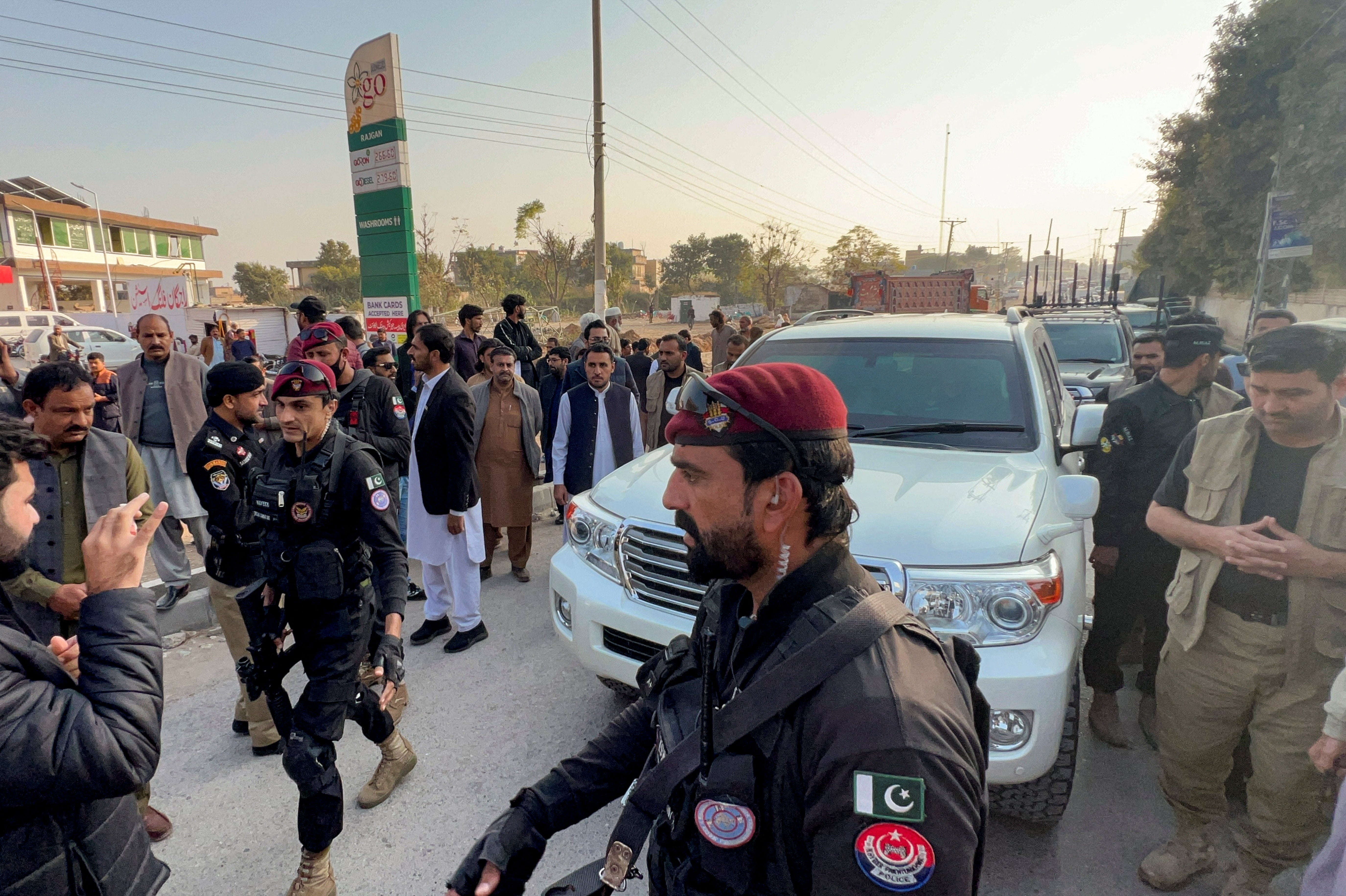 Police commandos escort a vehicle carrying Sohail Afridi, chief minister of Khyber Pakhtunkhwa province, as he, along with party workers, arrives to visit Khan on Thursday