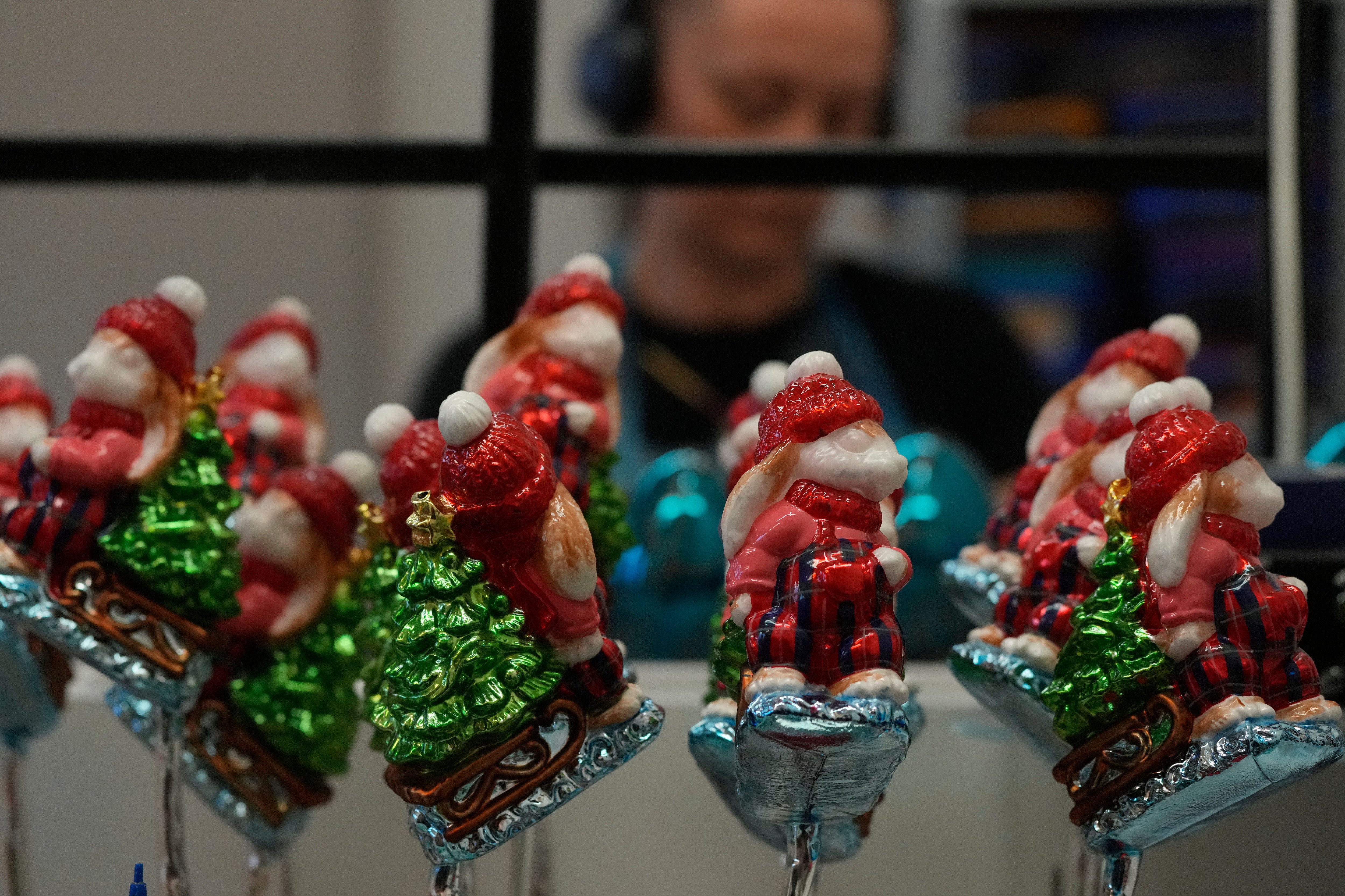 A worker prepares the handmade Christmas baubles at GlitterLab in Czestochowa, southern Poland