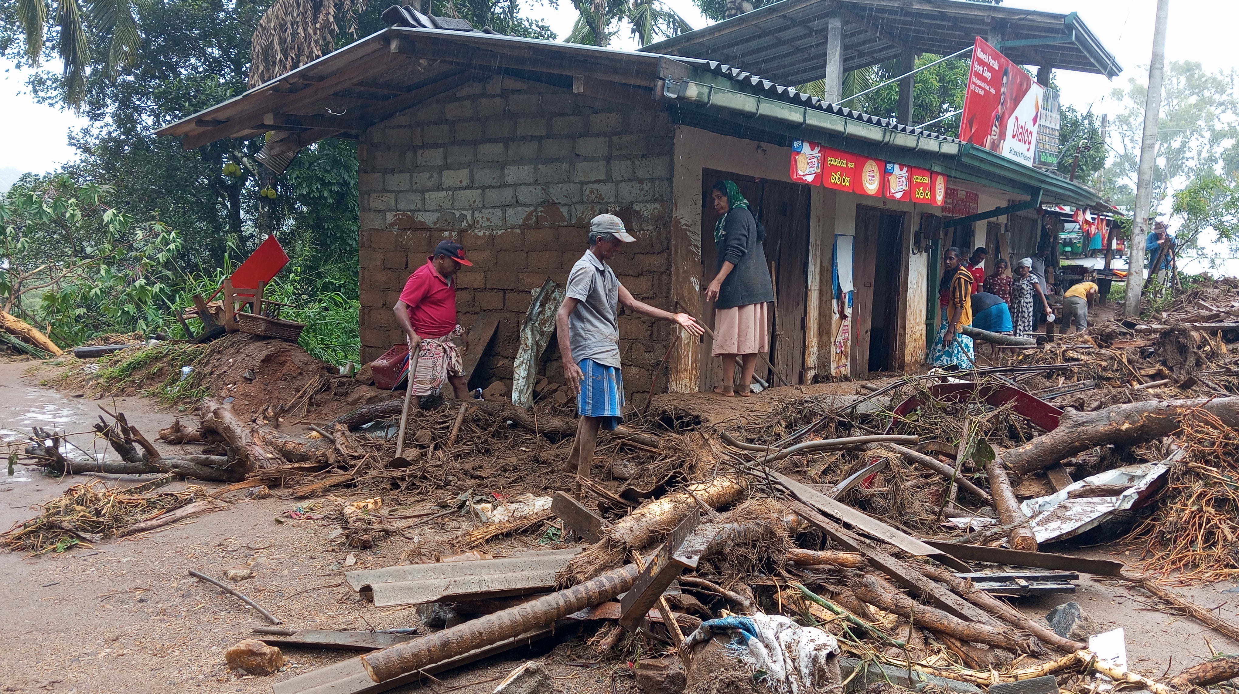 Landslide survivors clean the debris in Hanguranketha, Sri Lanka, on Saturday