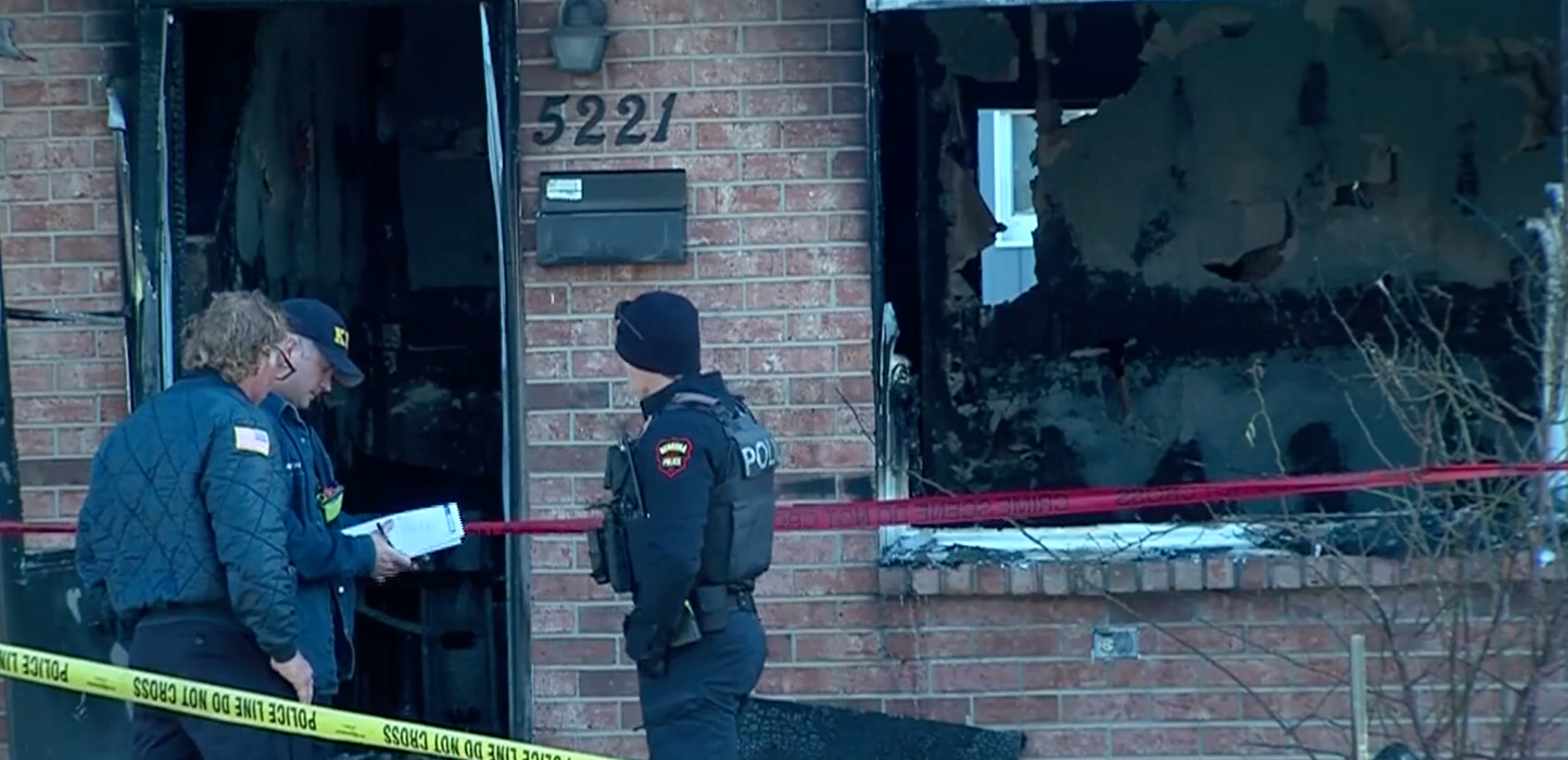 Law enforcement at a blackened building after a fire at a multi-family apartment building just after 10.30 p.m. on November 27