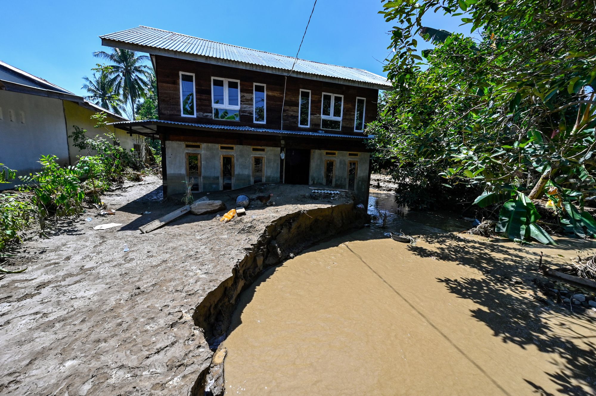a damaged house in a flooded area in Pidie Jaya district of Indonesia's Aceh province