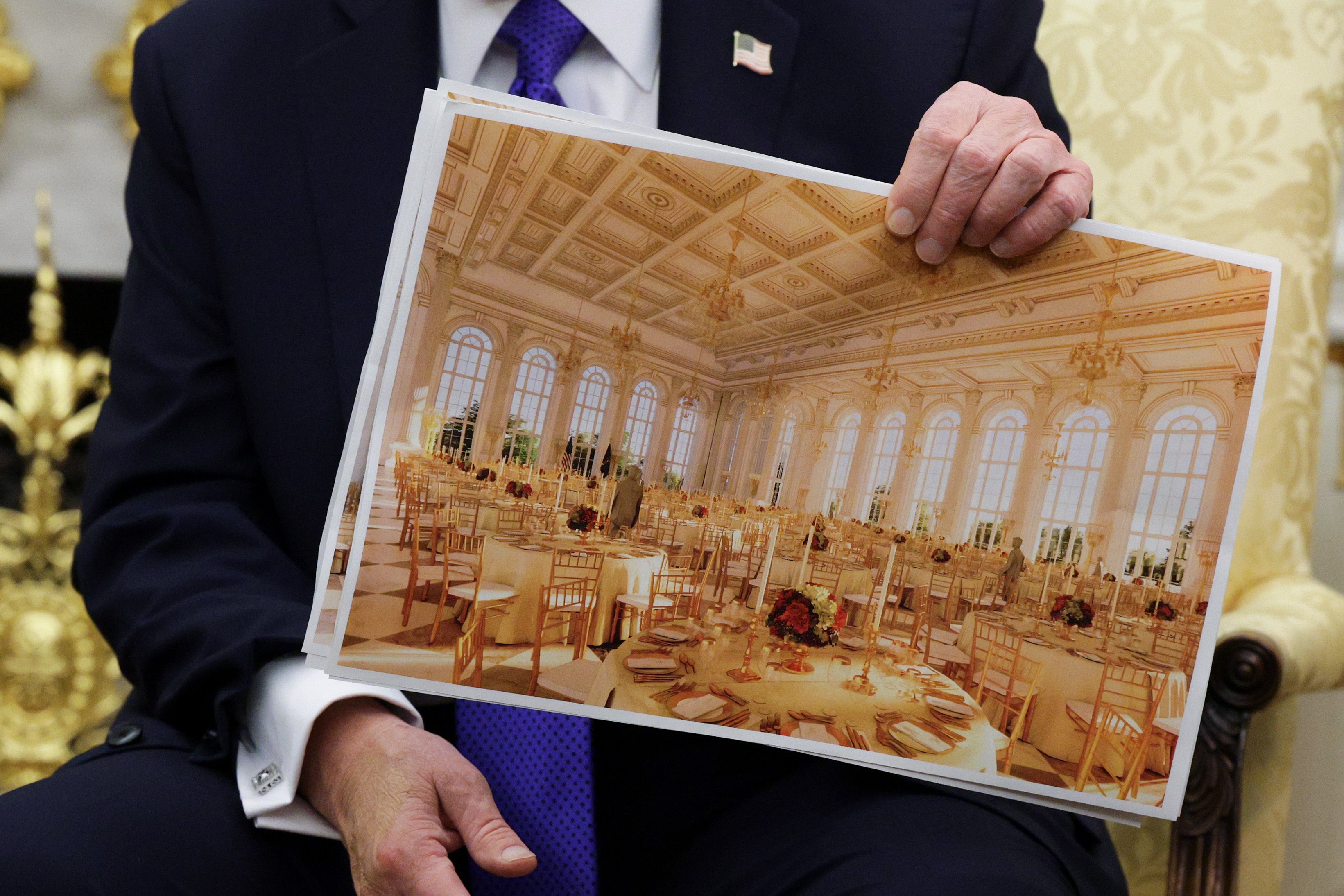 Trump holding up an artist’s rendering of the forthcoming ballroom during an Oval Office meeting with Nato Secretary General Mark Rutte in October