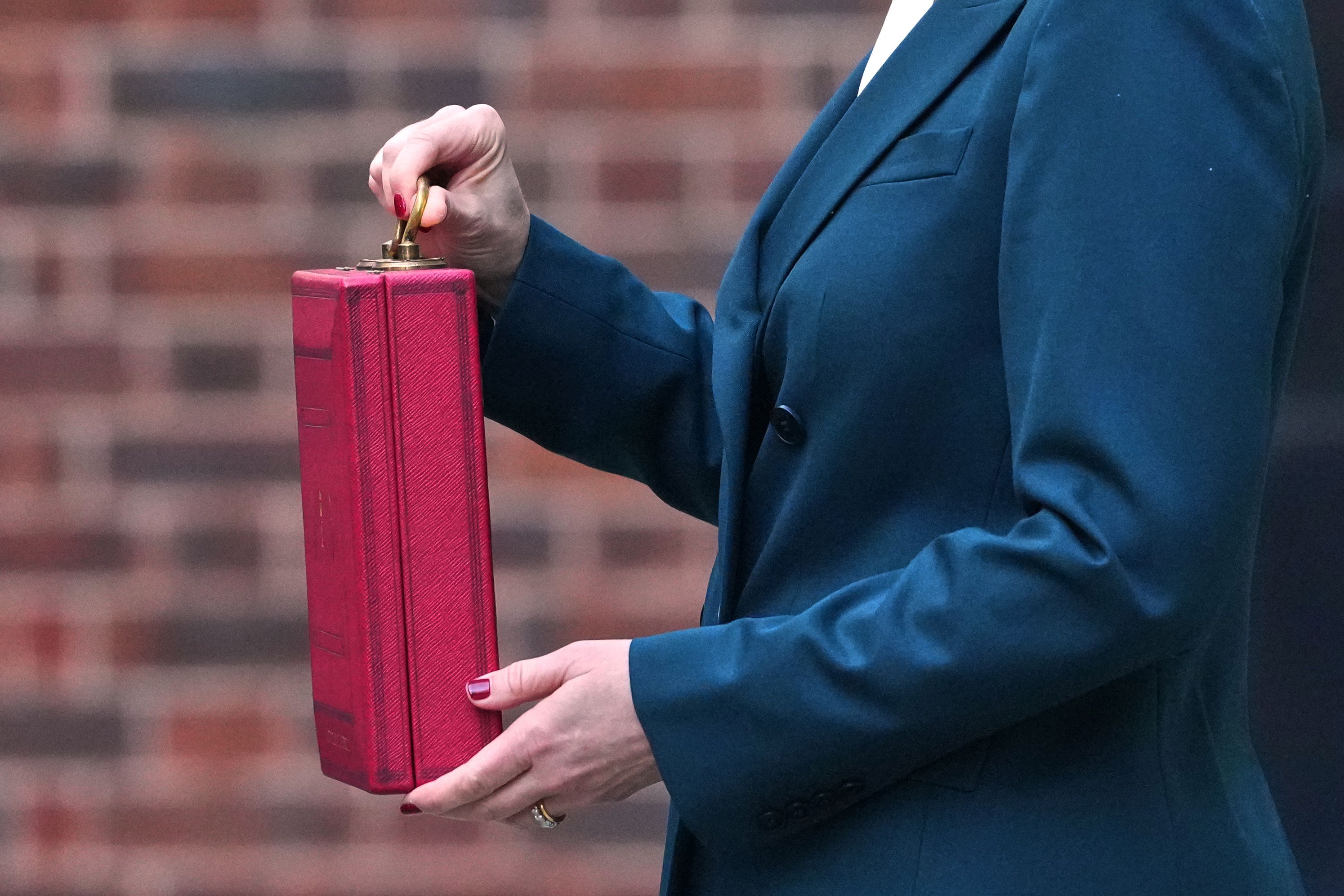 Chancellor Rachel Reeves poses outside 11 Downing Street, London, with her ministerial red box before delivering her Budget in the House of Commons (Frank Augstein/PA)