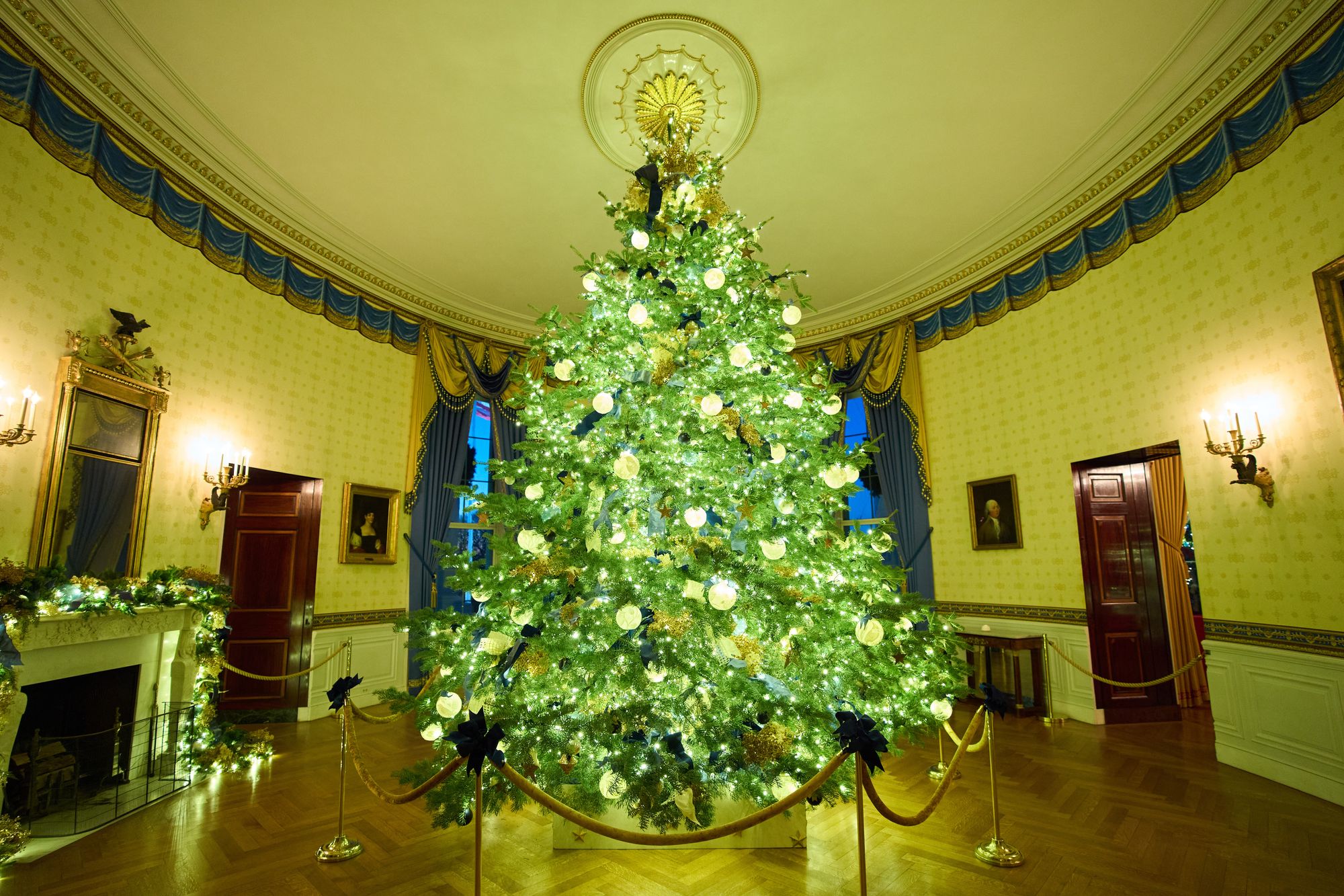 The Blue Room features the White House official Christmas tree, with one ornament for each of the 50 states