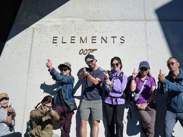 <p>Chinese influencers strike a James Bond pose outside the 007 Elements museum in Solden, Tyrol, Austria in July</p>