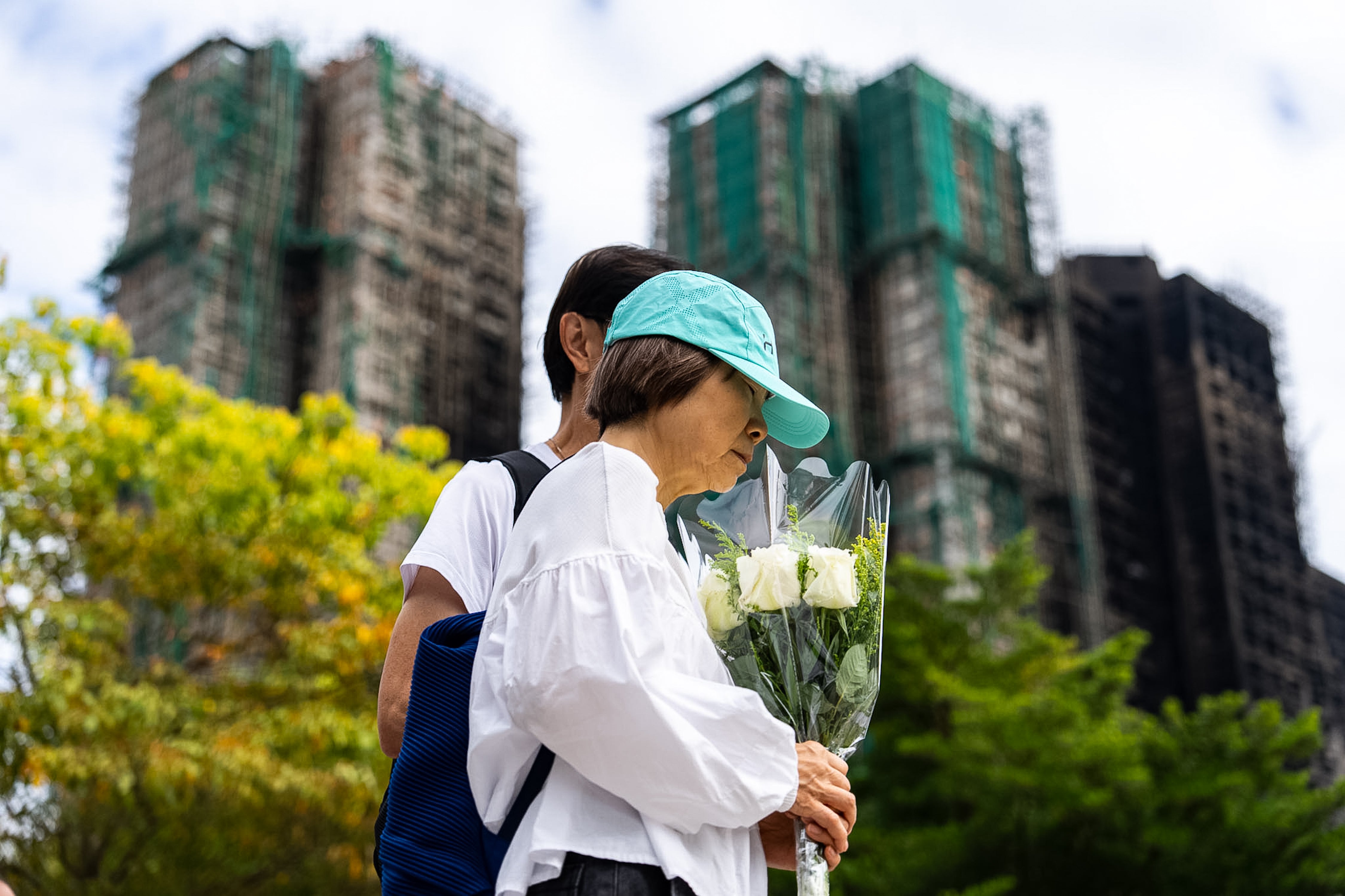 Laying flowers at the memorial site of Hong Kong fires