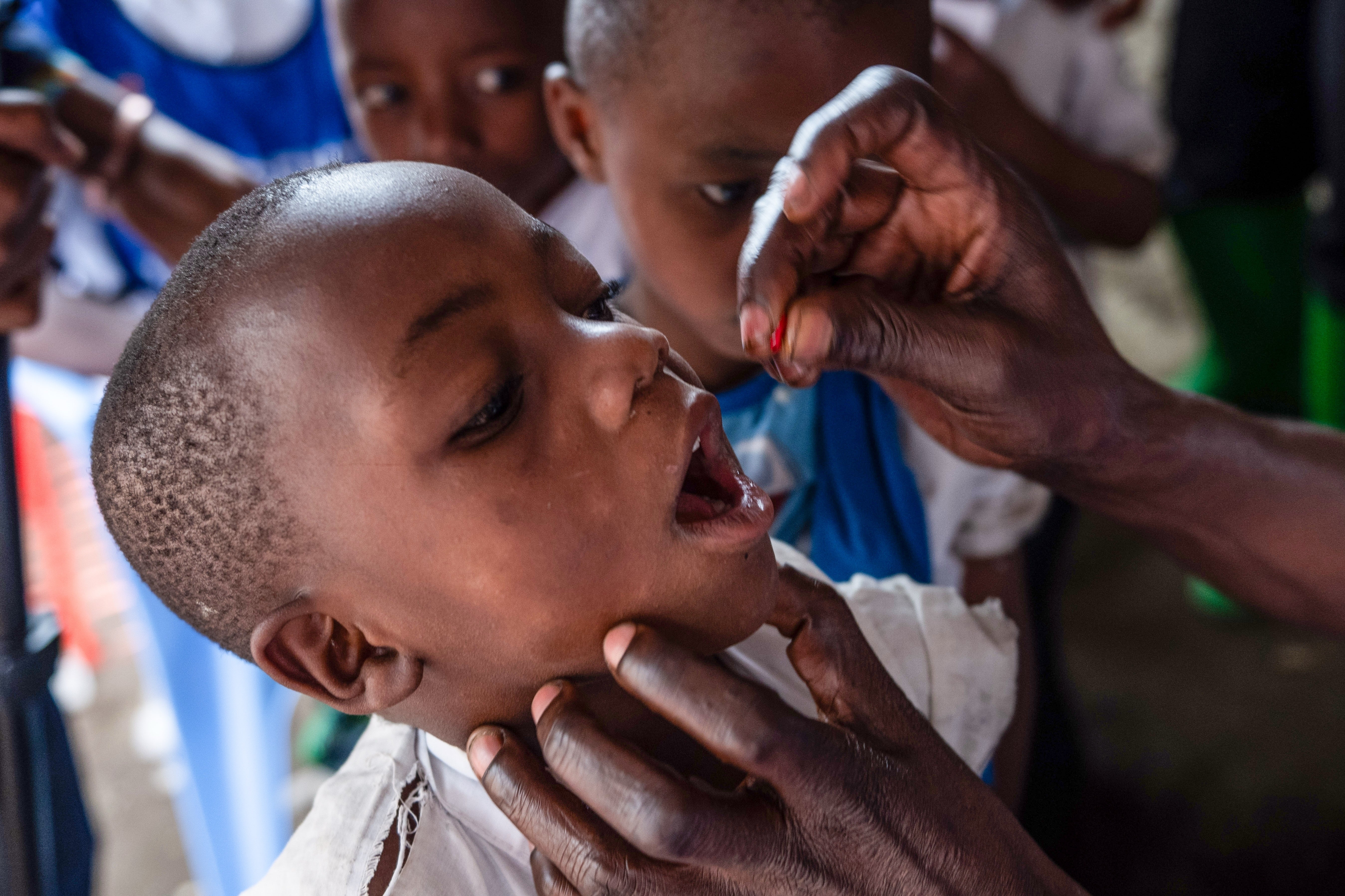 A school child receives a measles vaccination at the Kachehembe health center in Rubaya, eastern Democratic Republic of Congo