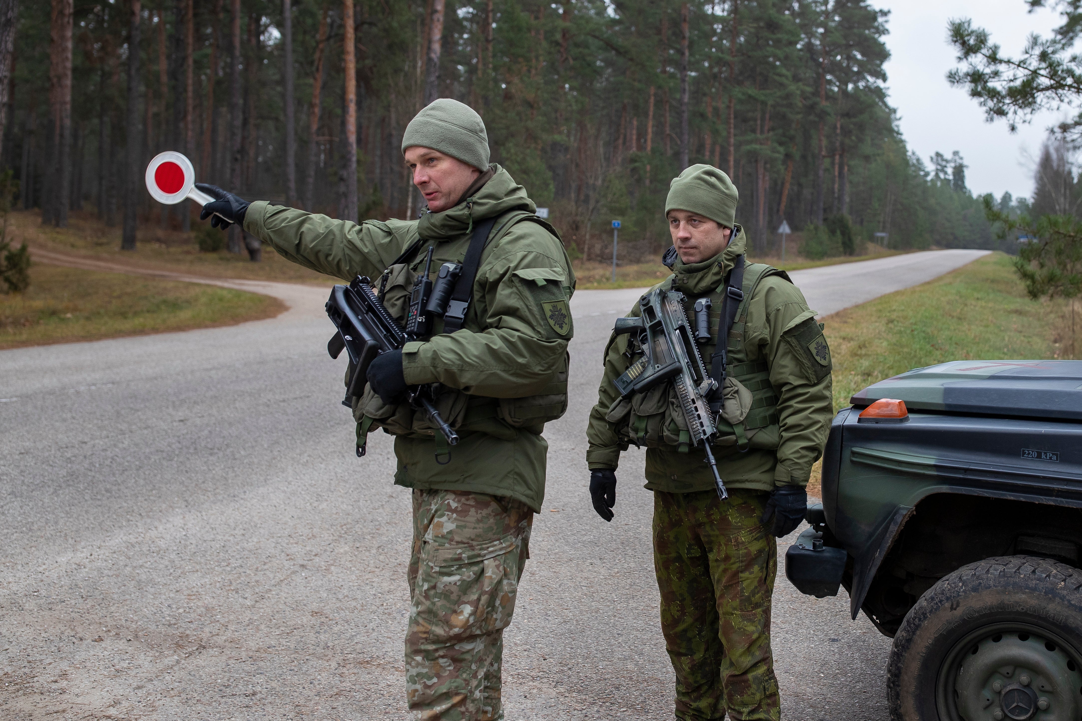 Lithuanian soldiers patrol a road near the Lithuania-Belarus border near the village of Jaskonys, Druskininkai district some 160 km (100 miles) south of the capital Vilnius, Lithuania, on Nov. 13, 2021. (AP Photo/Mindaugas Kulbis, File)