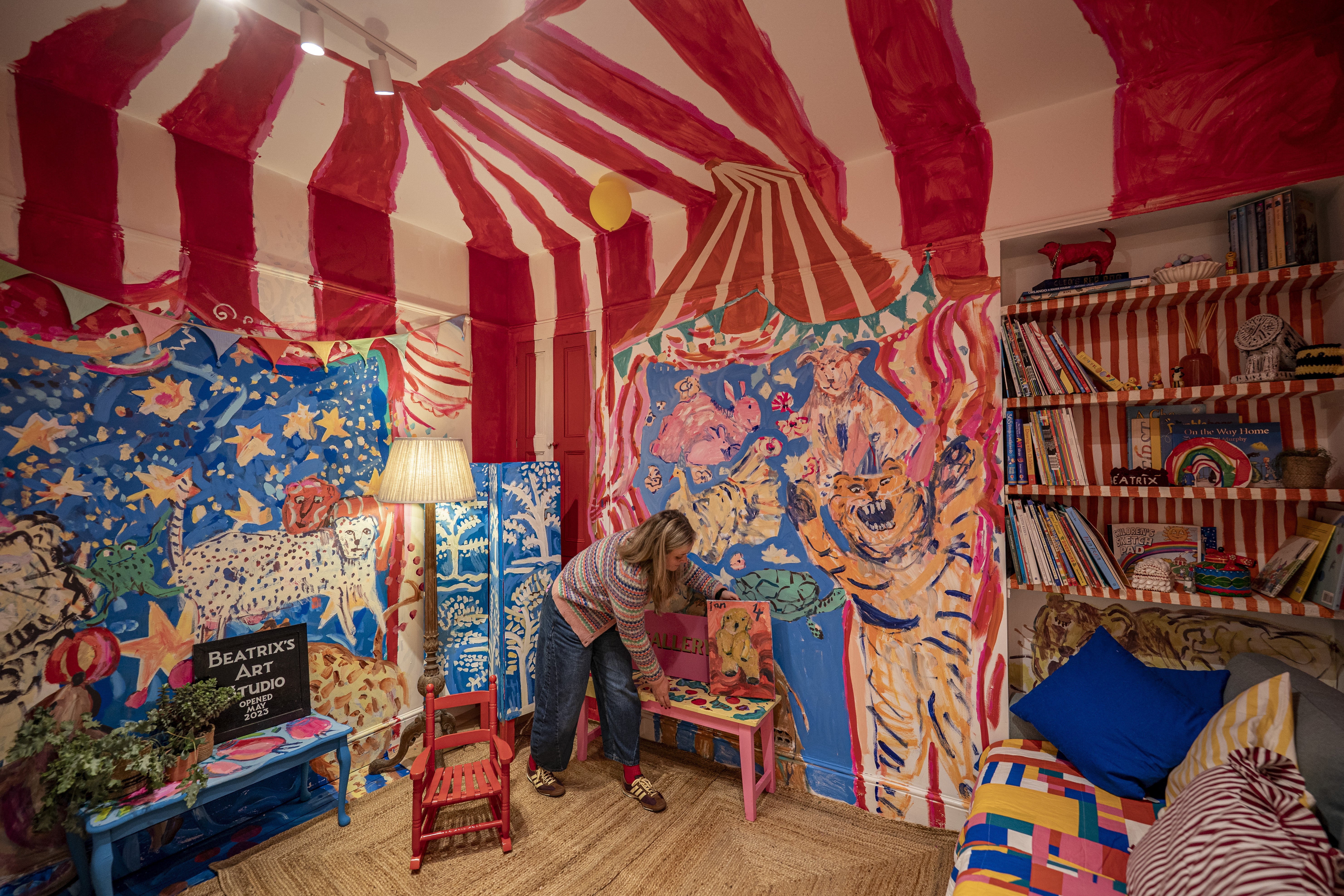 <p>Emily Powell tidies in her daughter’s playroom </p>