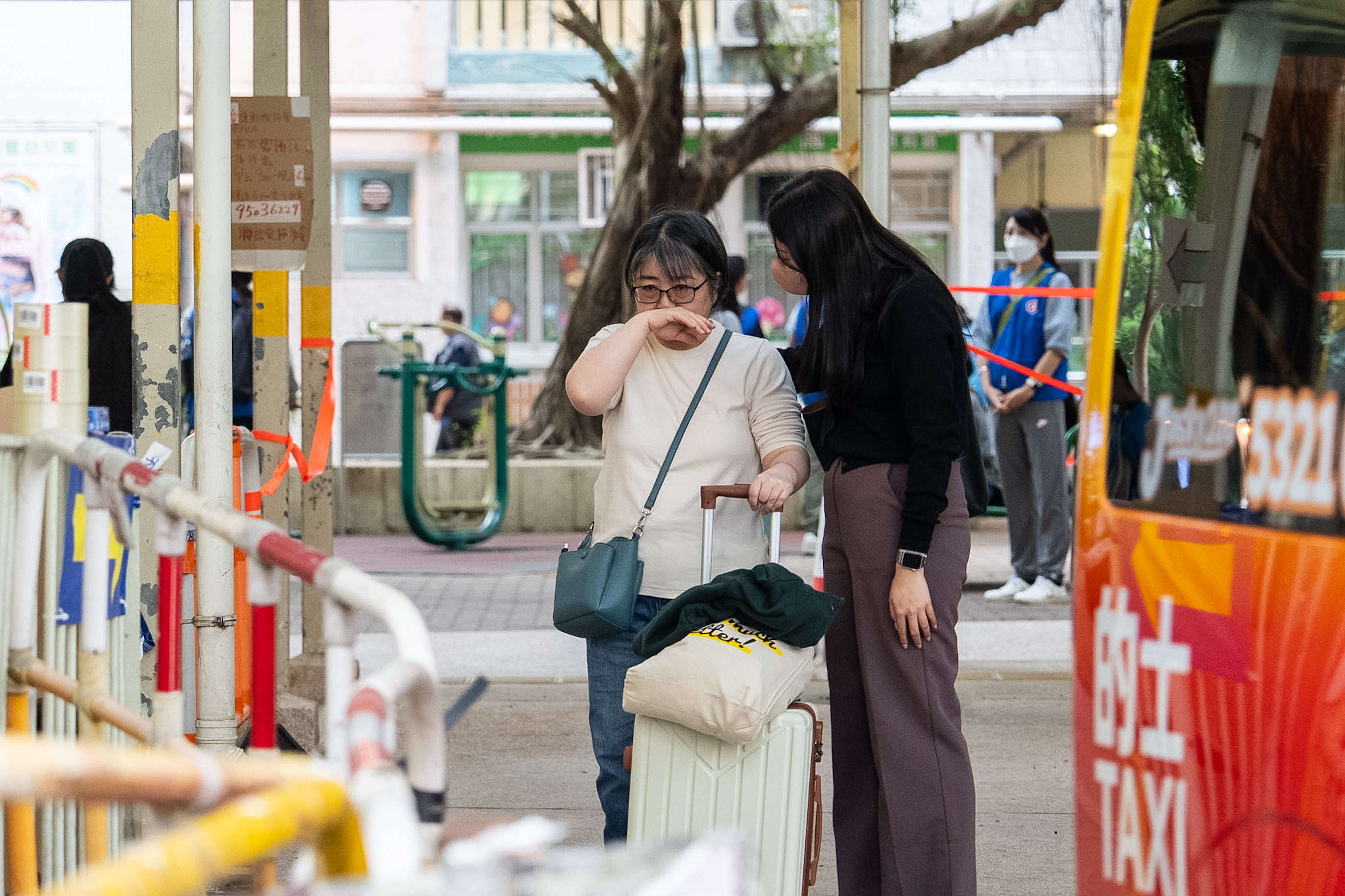 Residents react as they return to their homes to collect belongings after the Wang Fuk Court fire