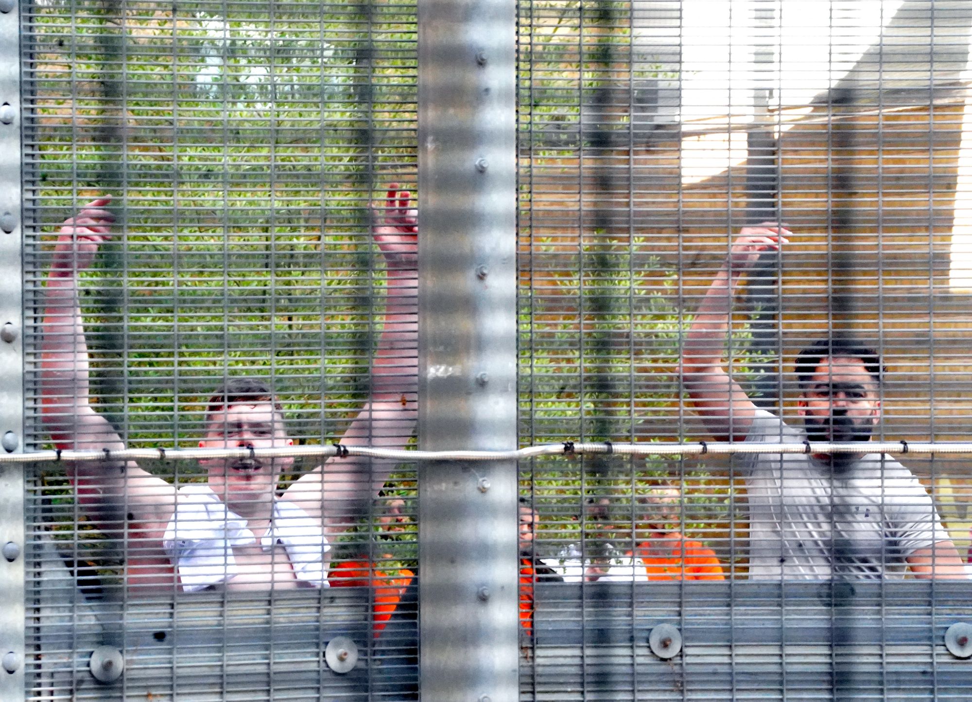 People held at Brook House Immigration Removal Centre at Gatwick respond to protesters outside.