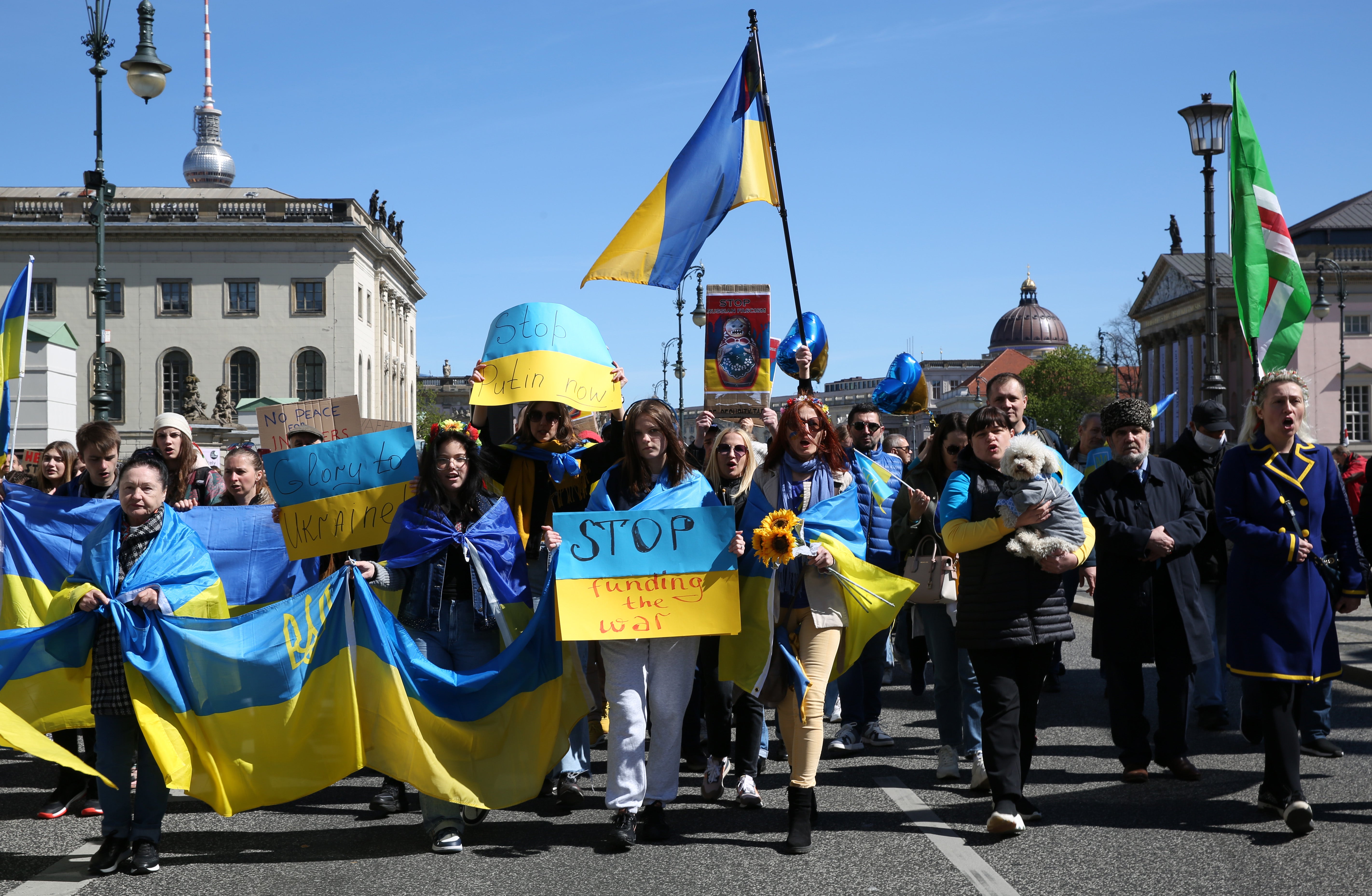 A woman representing a rape victim leads protesters in a march in Berlin against Russian military aggression, in April 2022