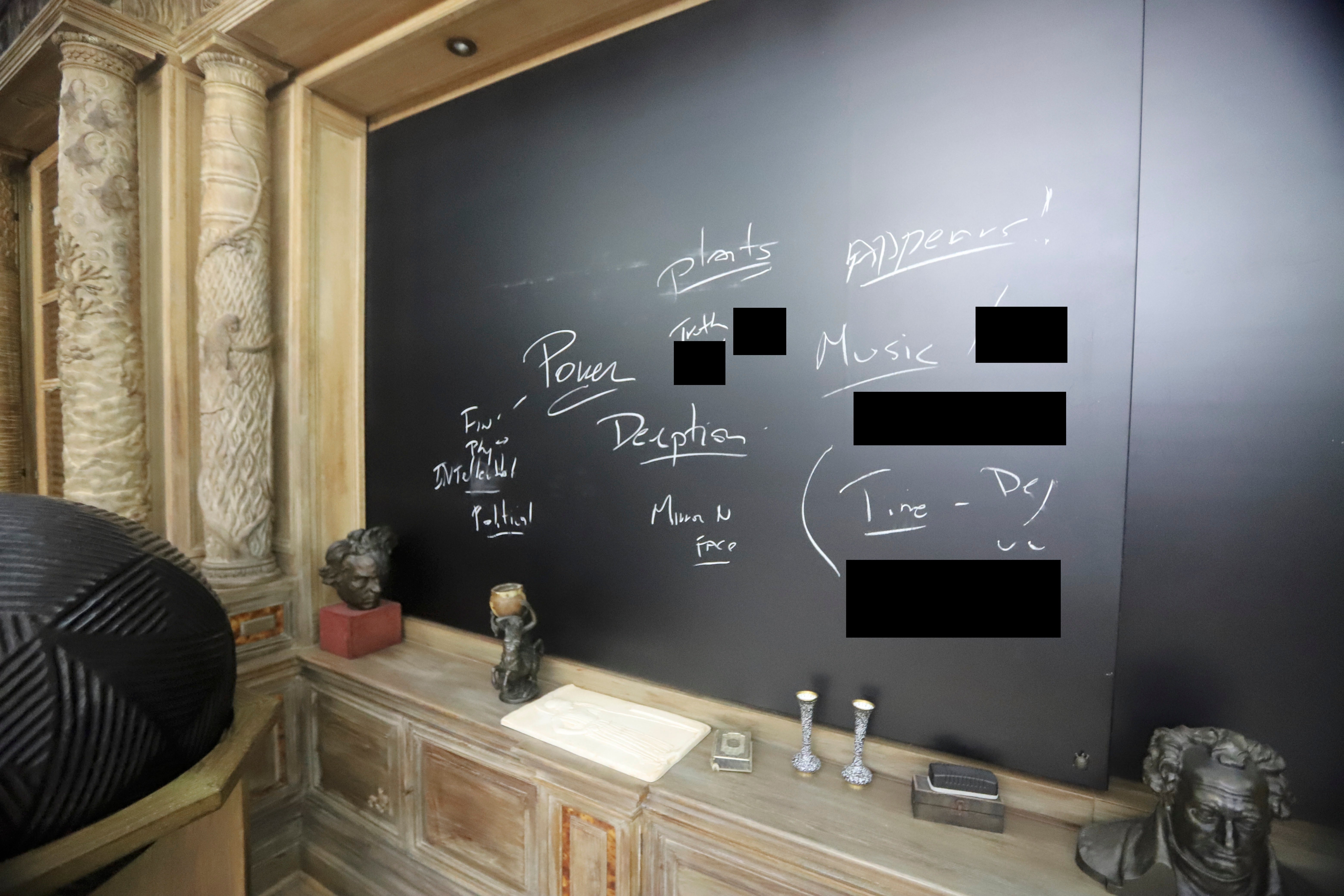 A photo of a chalkboard, located inside an office in Epstein’s estate, shows several words scribbled
