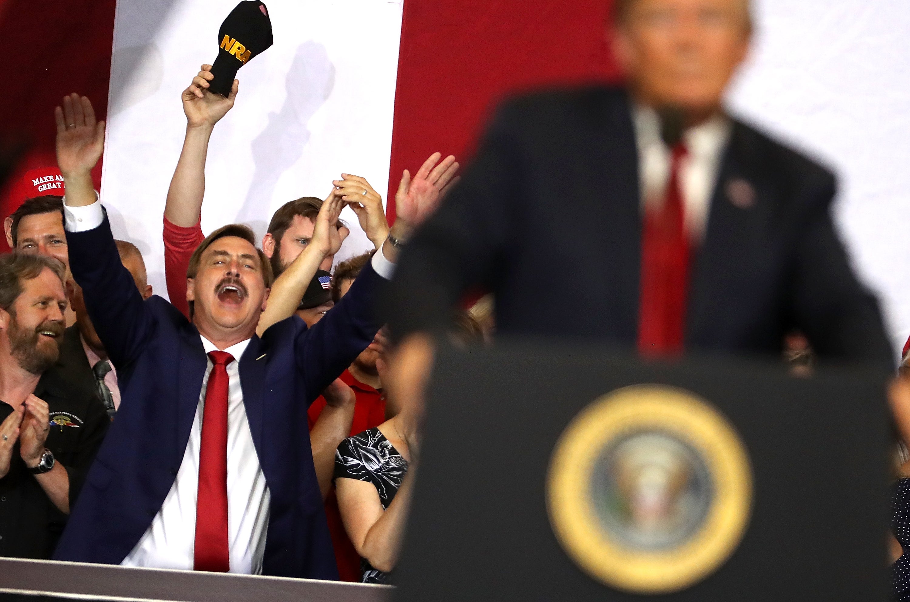 Mike Lindell cheers as President Trump speaks at a campaign event in North Dakota in 2018
