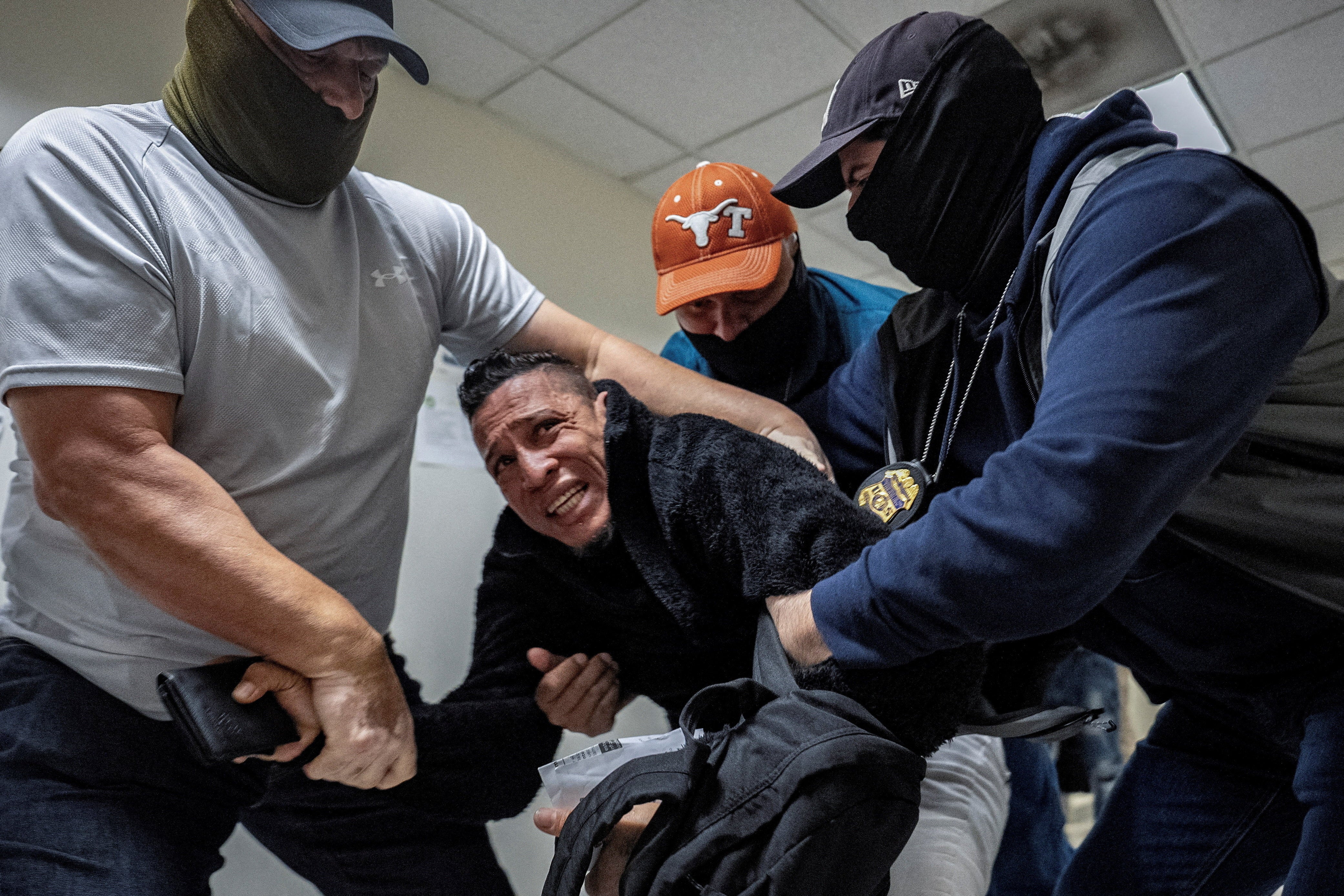 Masked U.S. Immigration and Customs Enforcement (ICE) agents and federal officers detain a migrant as he walks out from a hearing during targeted detainment at a U.S. immigration court in Manhattan, in New York City, U.S., October 27, 2025. Immigration arrests have spiked under President Donald Trump’s administration, but are still well below the administration’s stated goal of 3,000 arrests per day