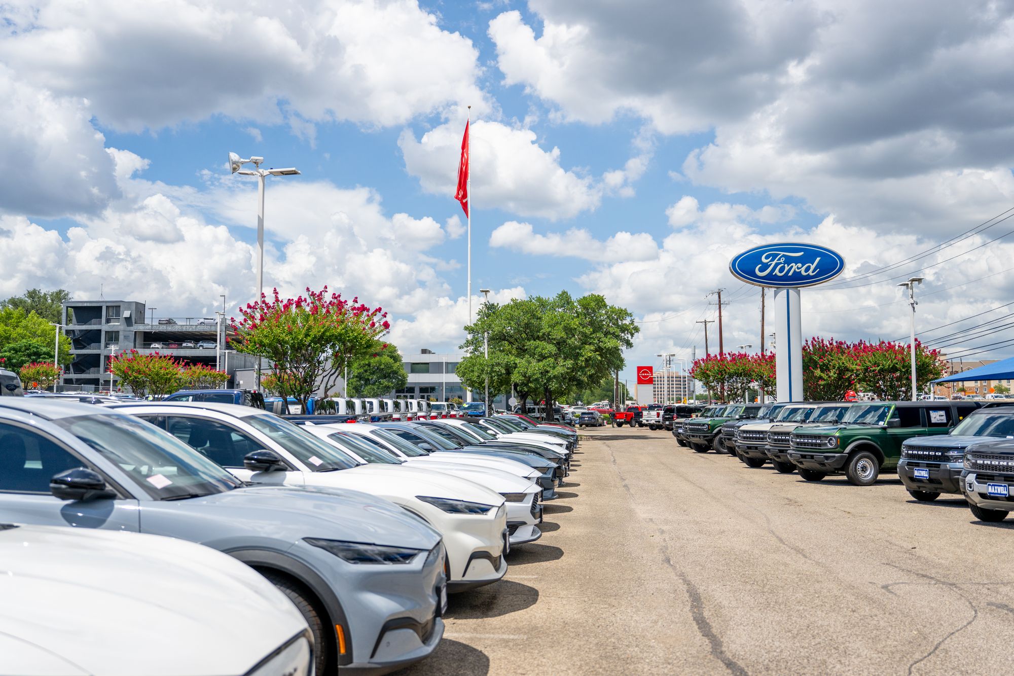 Ford Mustang Mach-E vehicles are seen for sale on a dealership lot on June 24, 2025 in Austin, Texas