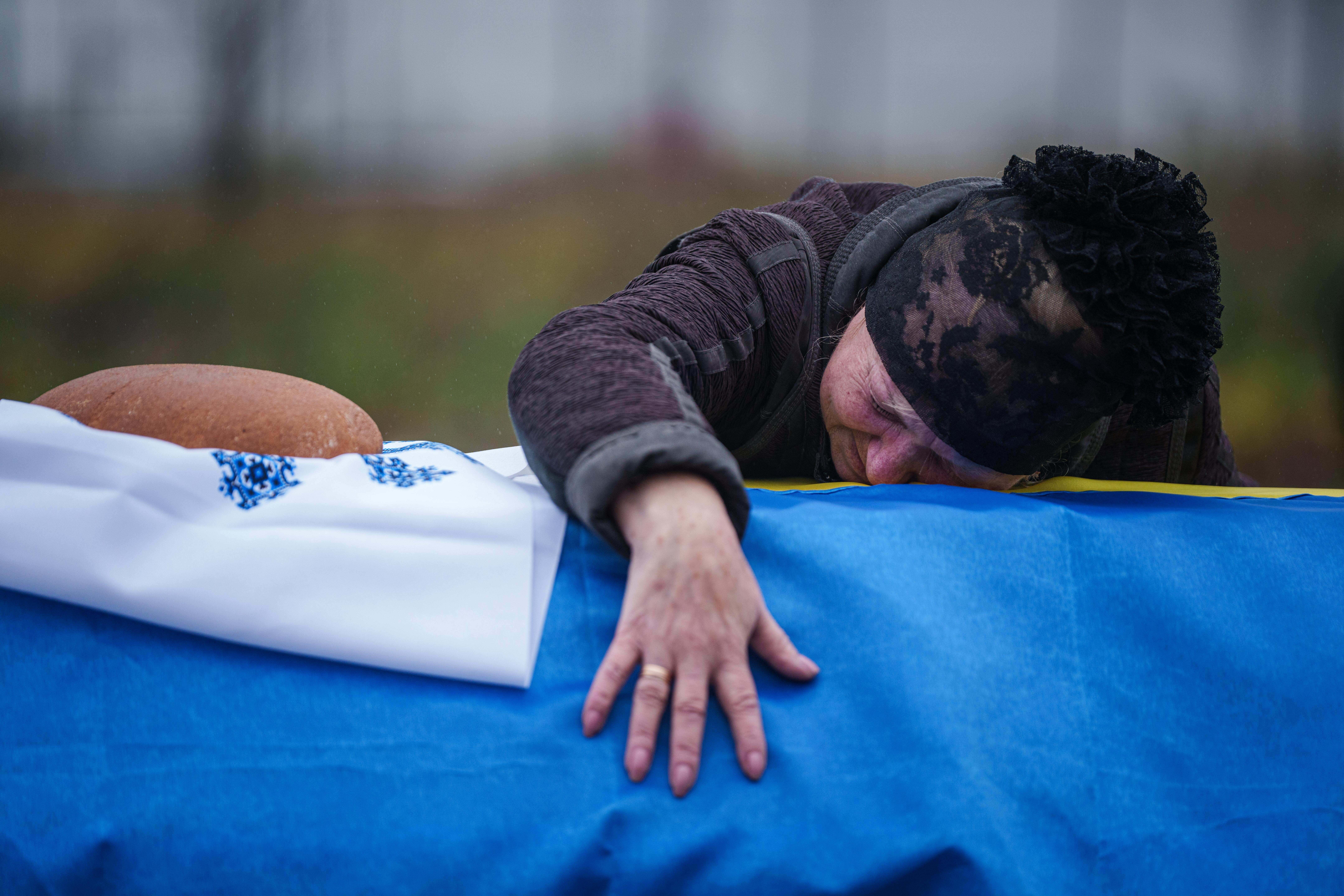 A mother cries at the coffin of her son Oleh Borovyk, who was killed by Russian forces near Pokrovsk