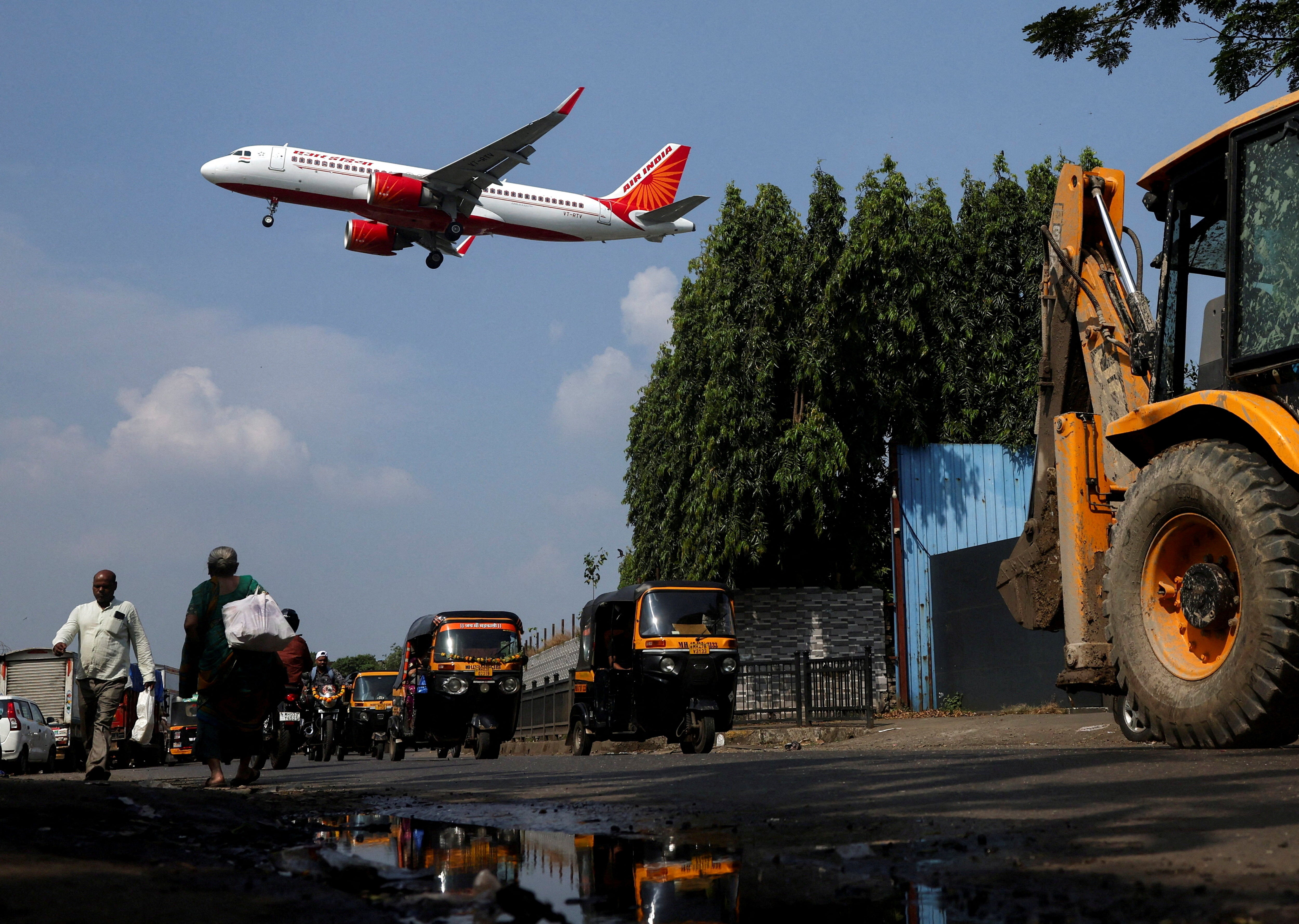 <p>An Air India aircraft flies low as it prepares to land in Mumbai</p>