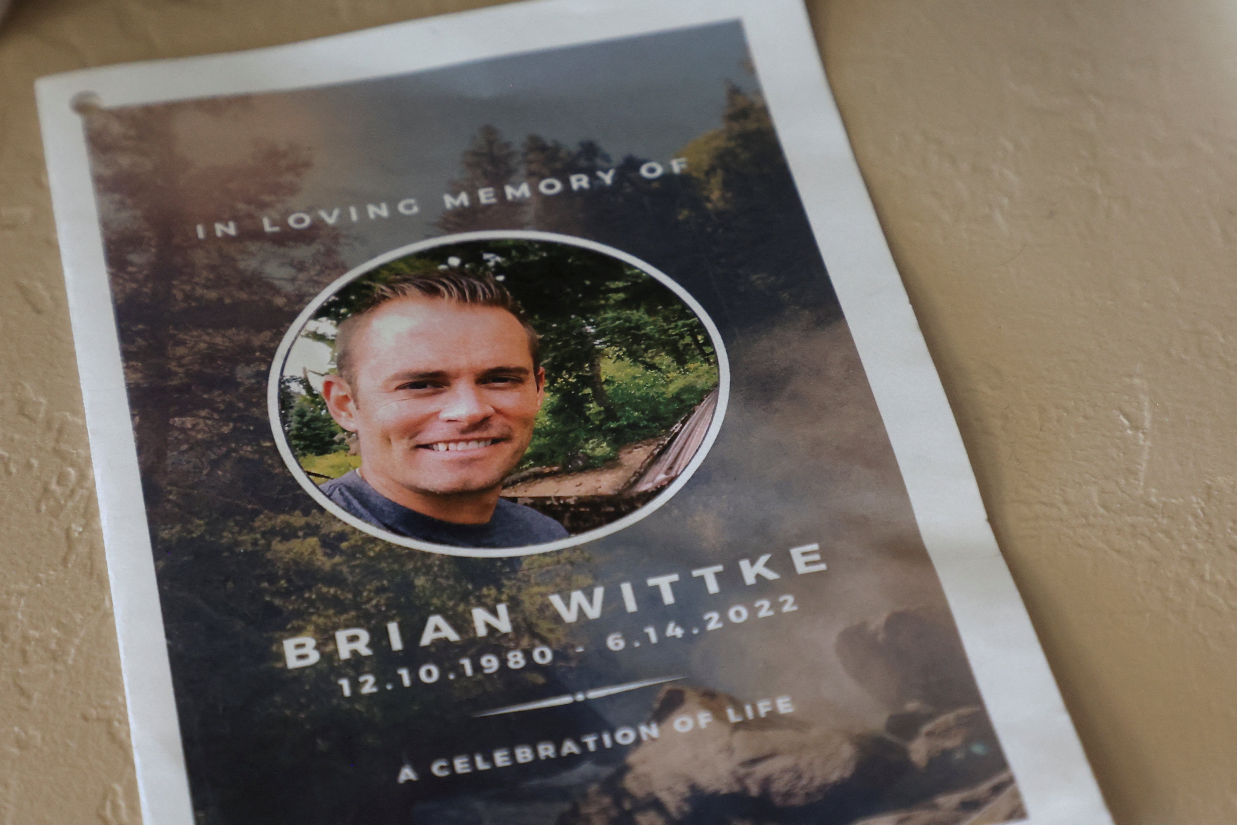 A pamphlet from a celebration of life event for Brian Wittke lies on a memorial shelf at his mother's home in Glendale, Arizona