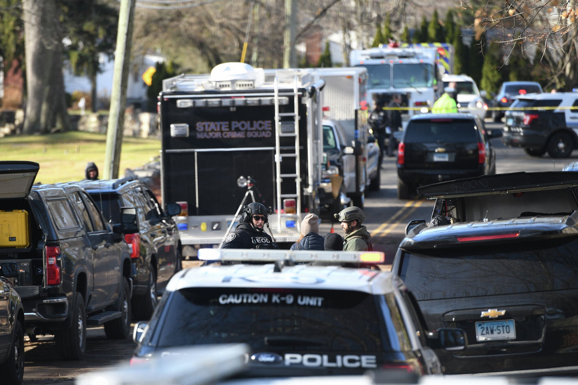 Law enforcement officers respond near a home where a man shot at officers and a decomposed body was later found in Stamford, Conn., Tuesday, Dec. 2, 2025. (Tyler Sizemore/Hearst Connecticut Media via AP)