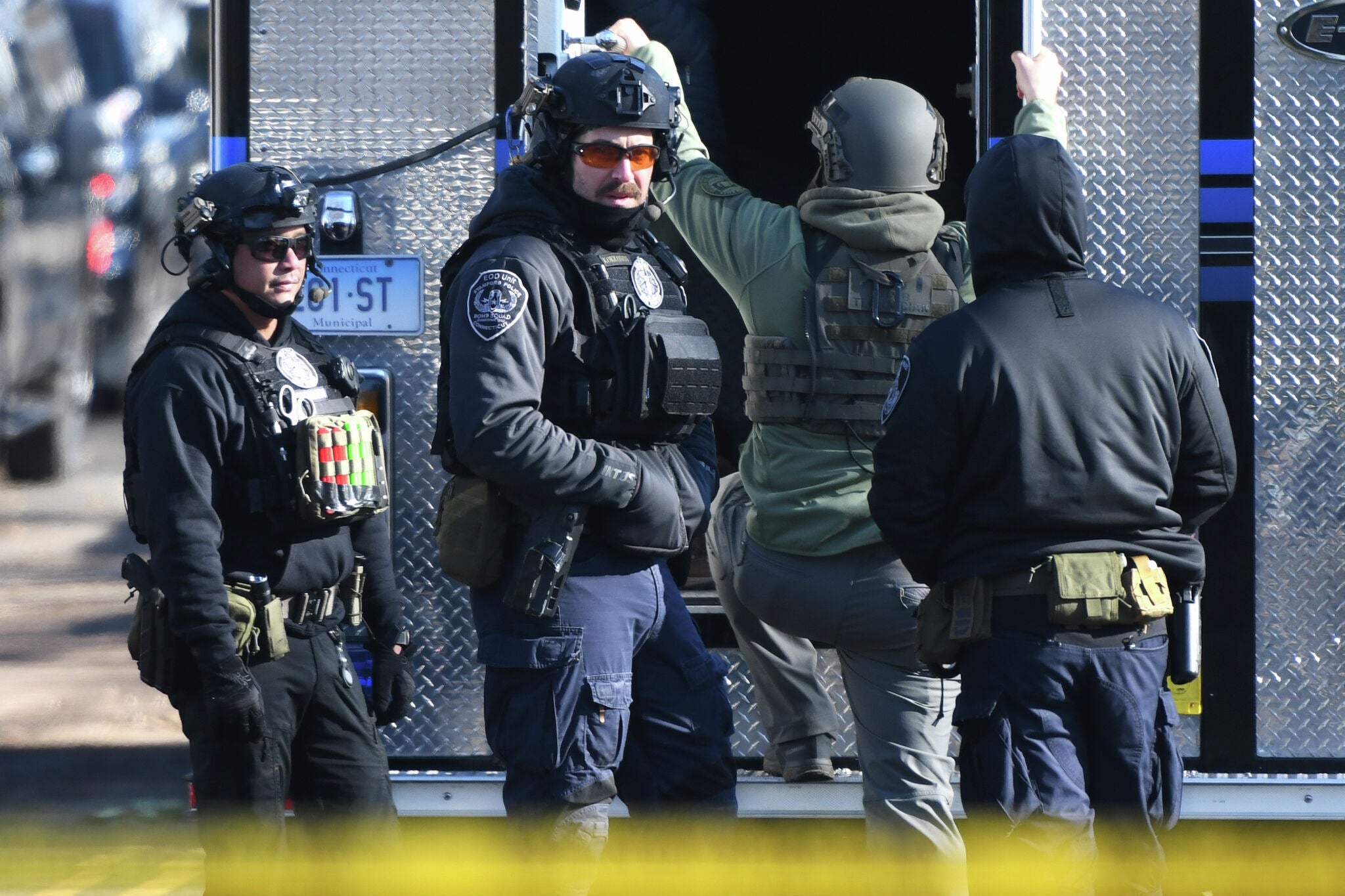 Law enforcement officers respond near a home where a man shot at officers and a decomposed body was later found in Stamford, Conn., Tuesday, Dec. 2, 2025. (Tyler Sizemore/Hearst Connecticut Media via AP)