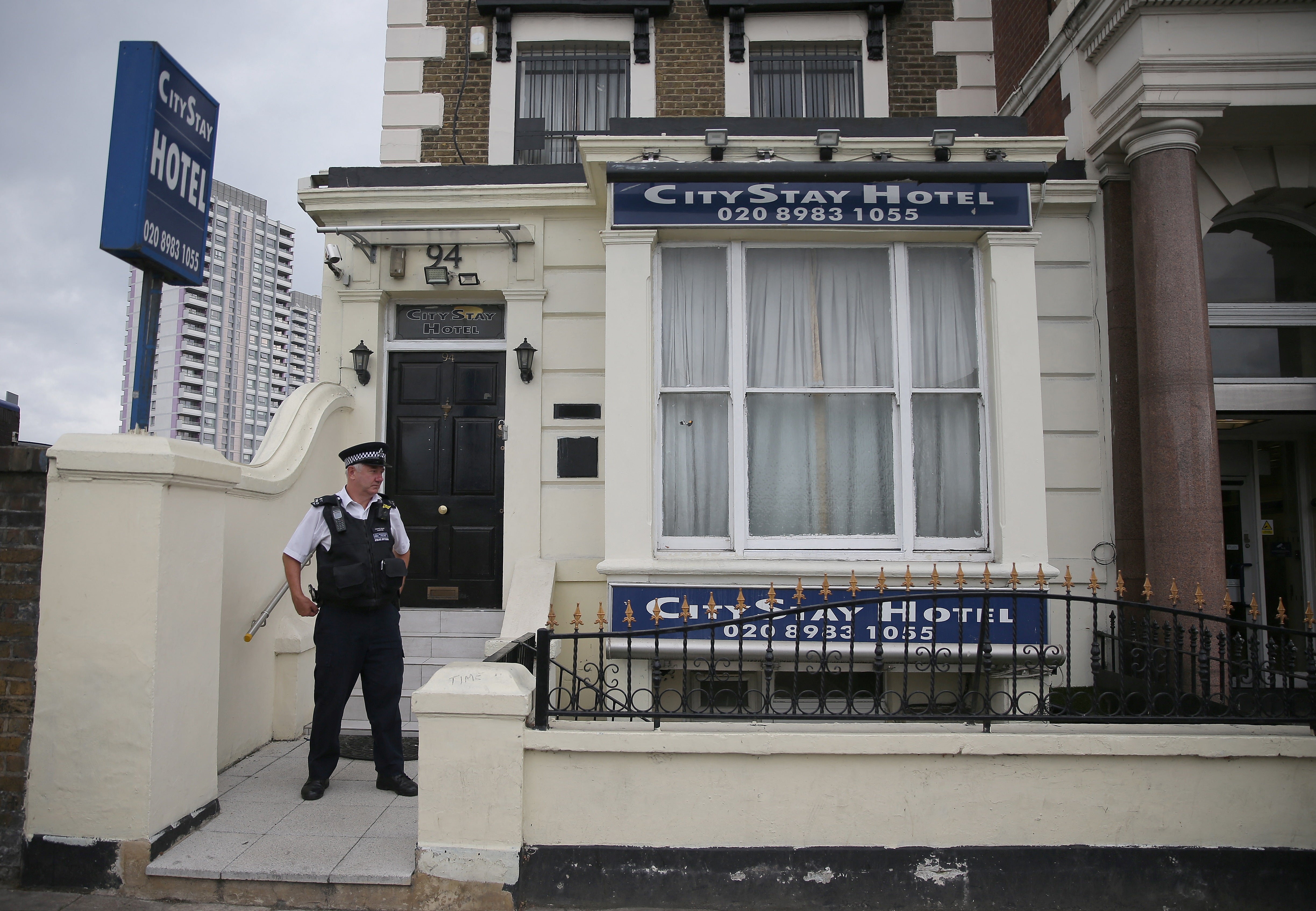 A police officer stands outside the City Stay Hotel, where the Russian agents booked rooms