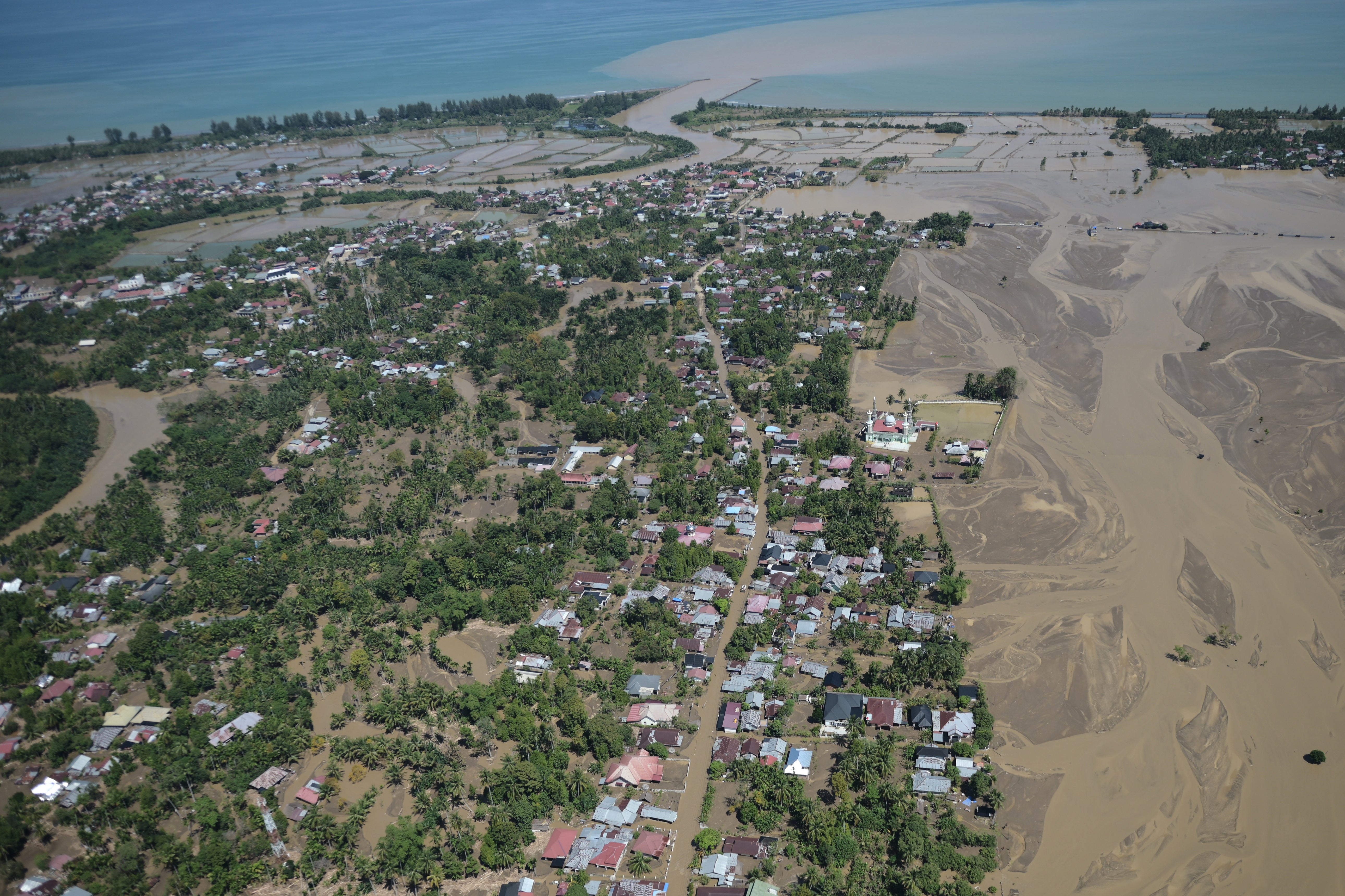 Helicopter during an aerial aid distribution shows an area affected by floods in Pidie Jaya, Aceh province, Indonesia