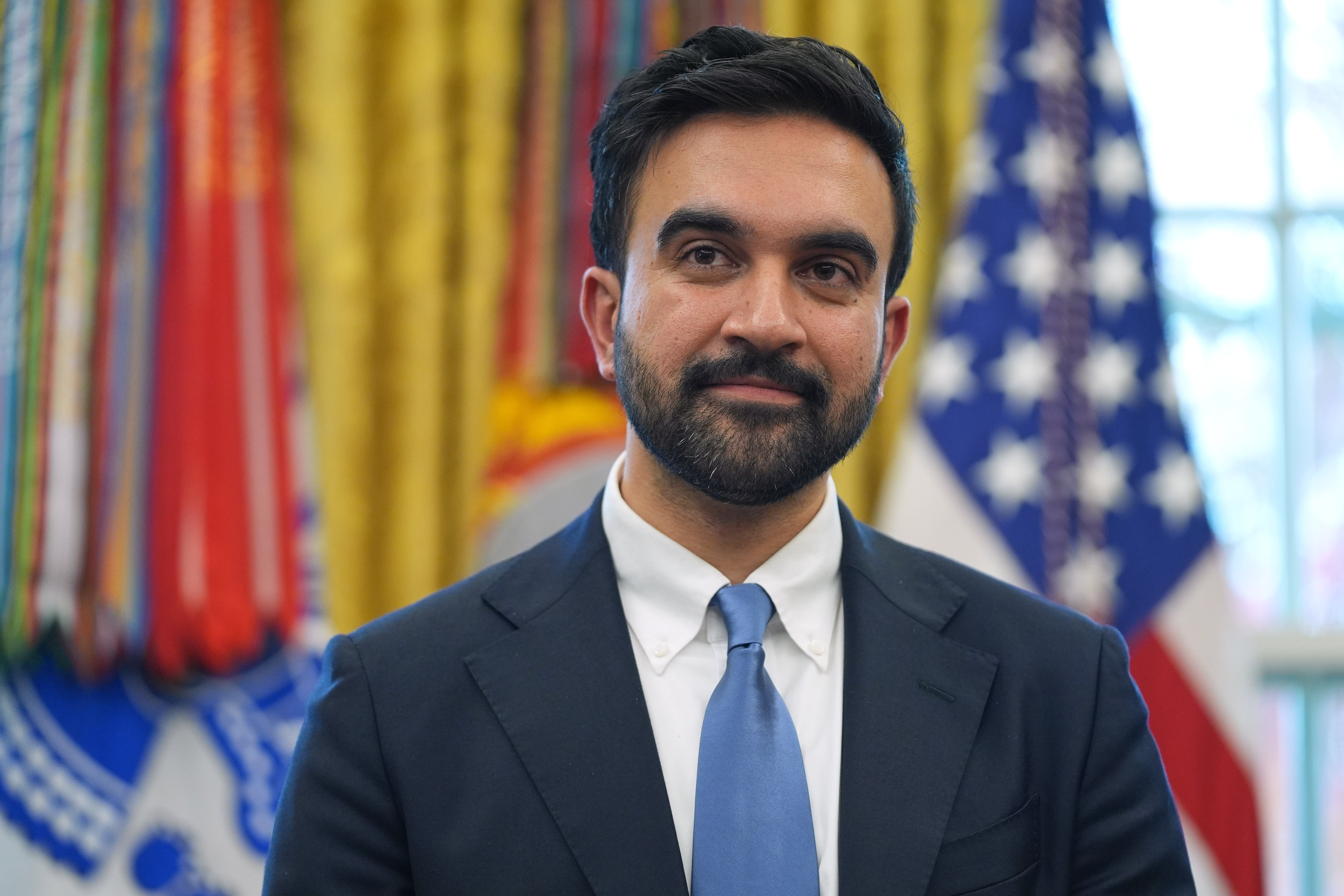 New York City Mayor-elect Zohran Mamdani listens as President Donald Trump speaks in the Oval Office of the White House, Friday, Nov. 21, 2025, in Washington