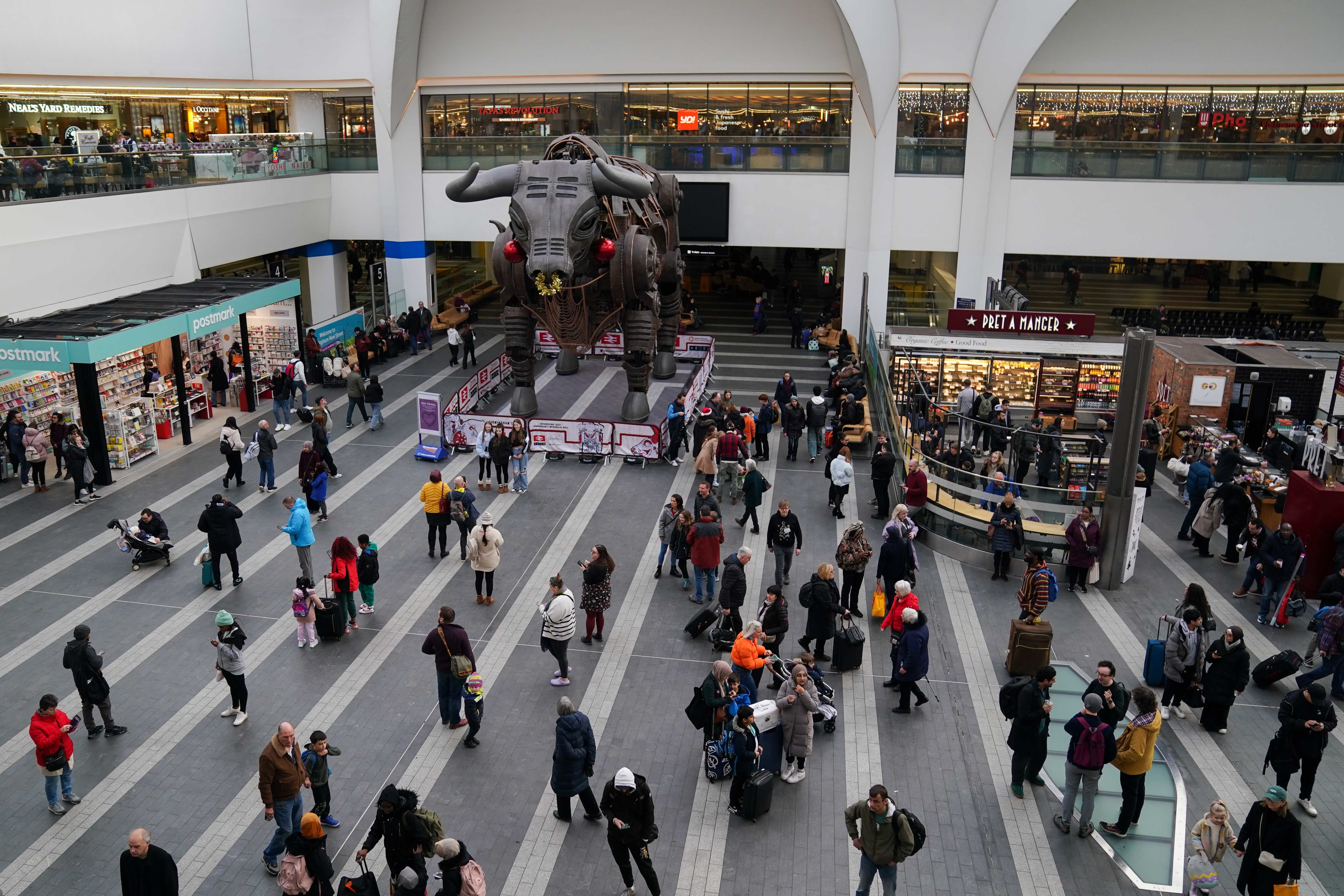 People look at information boards at New Street station in Birmingham