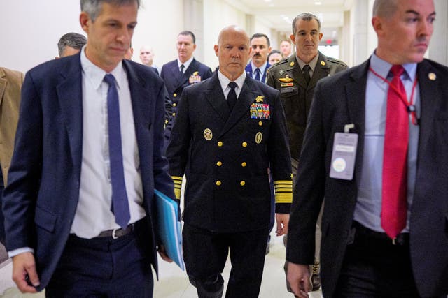 <p>Navy Admiral Frank ‘Mitch’ Bradley (center) arrives for a closed-door briefing to lawmakers</p>