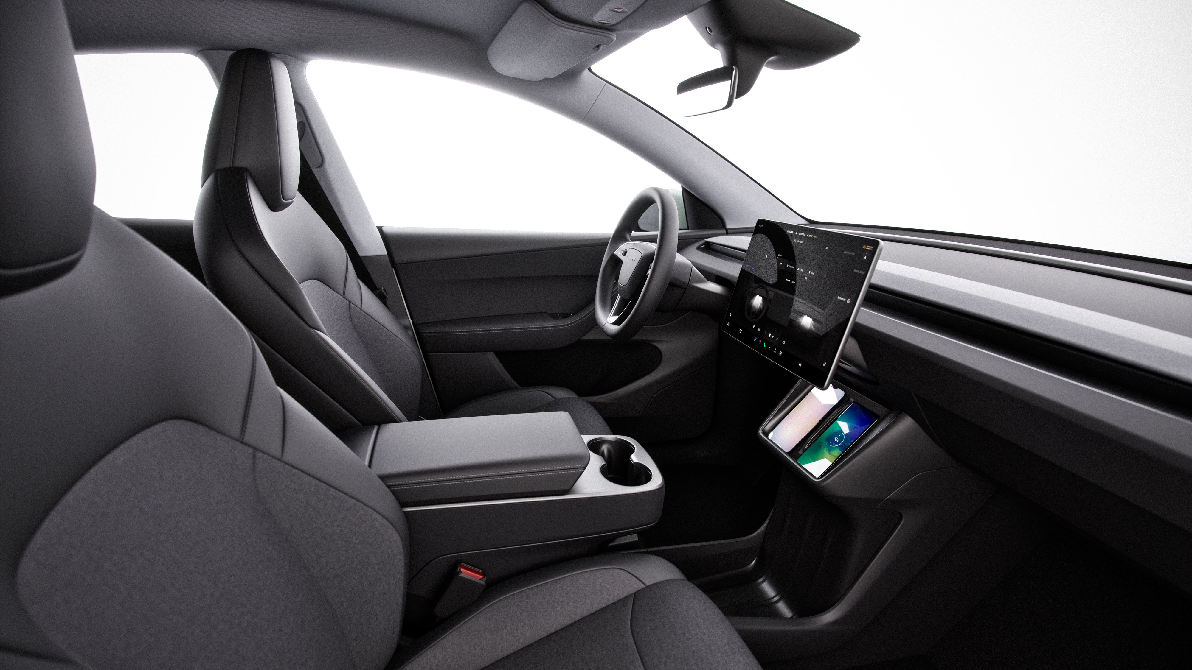 The interior of the new Tesla Model Y Standard features cloth seats and less spec