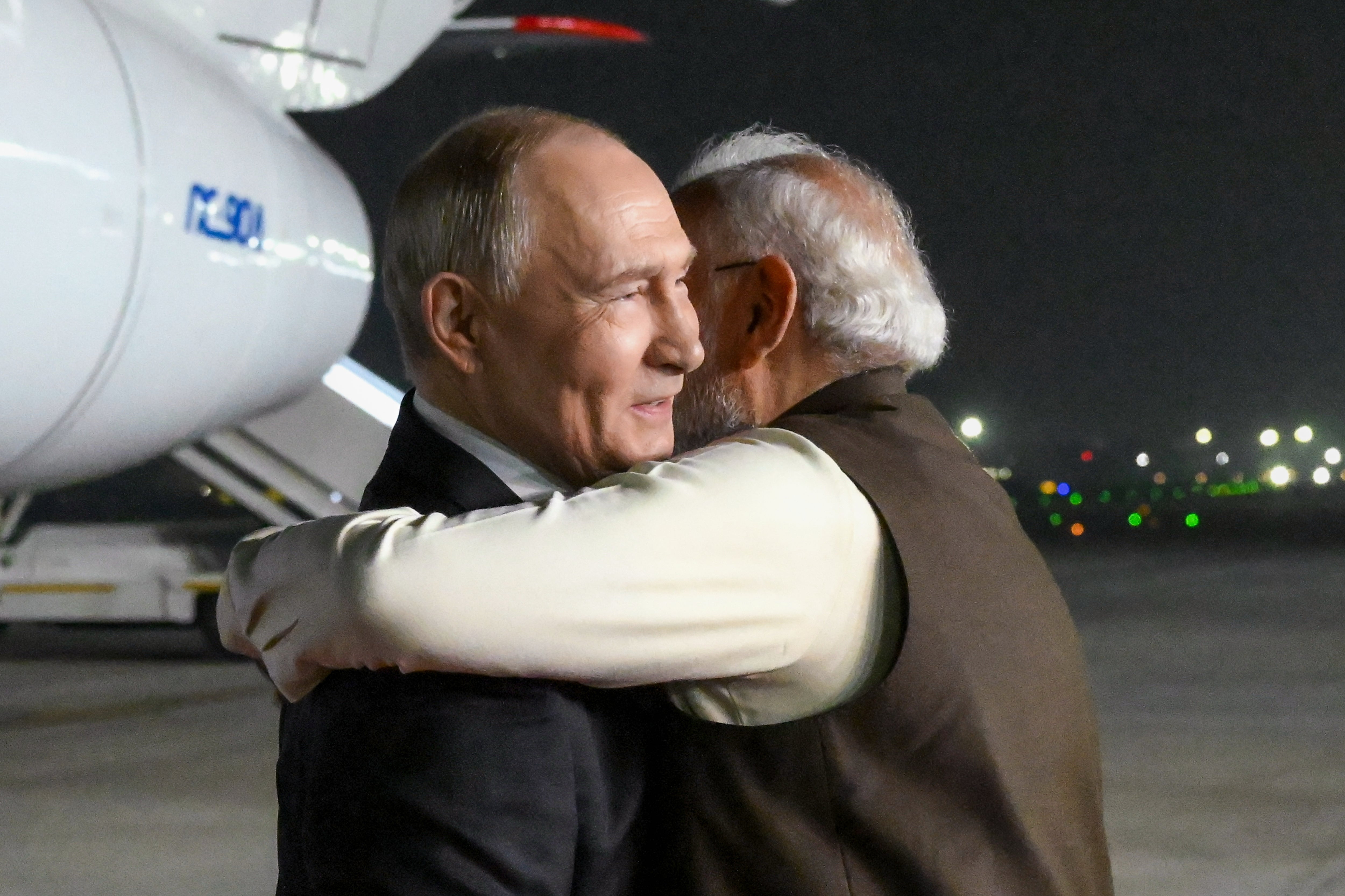 Russian President Vladimir Putin, left, and Indian Prime Minister Narendra Modi embrace each other at the Palam Air Base in New Delhi, India, Thursday, Dec. 4, 2025