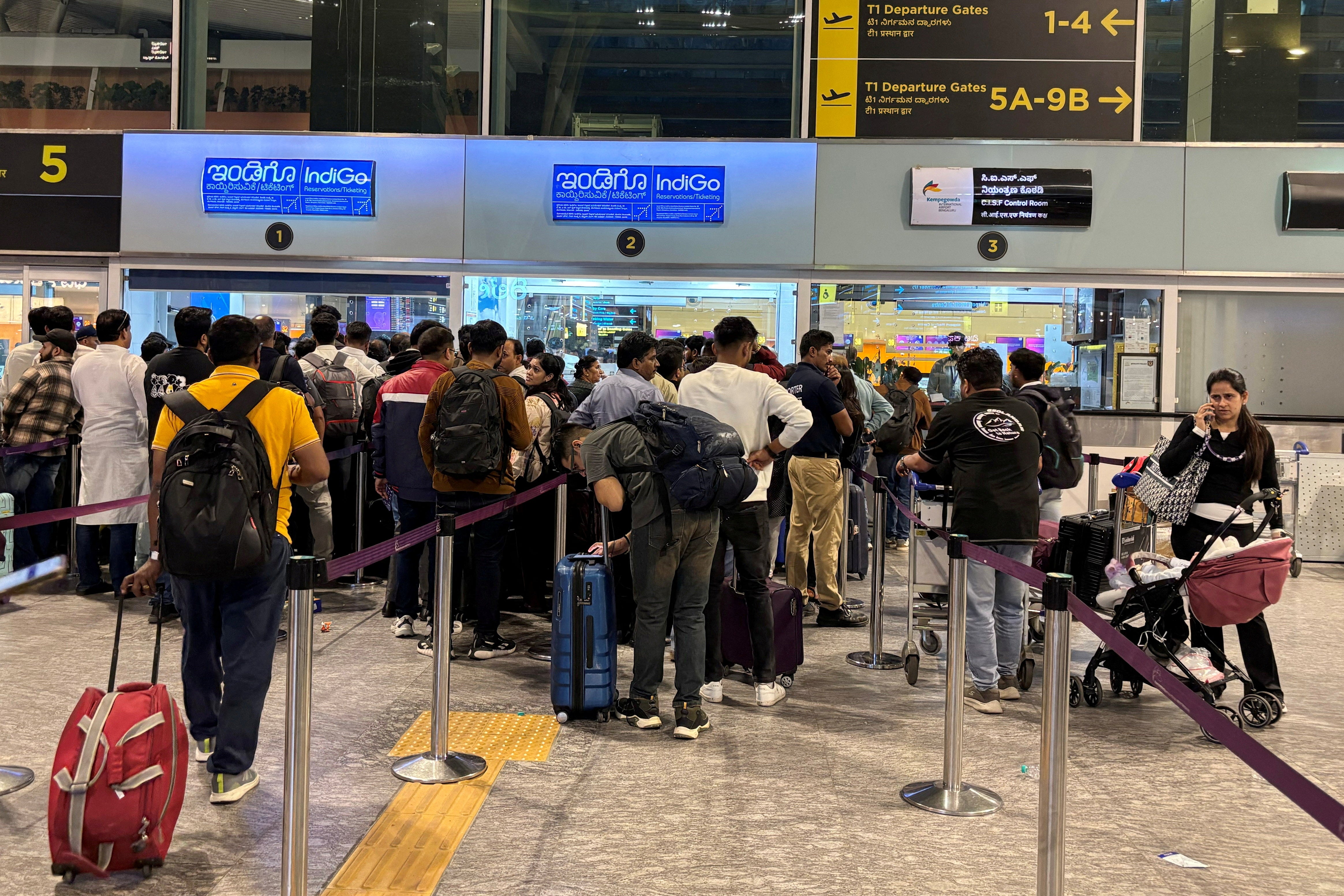 <p>Travelers wait in queues at IndiGo ticketing kiosks to reschedule their flights at Kempegowda International Airport in Bengaluru, India</p>