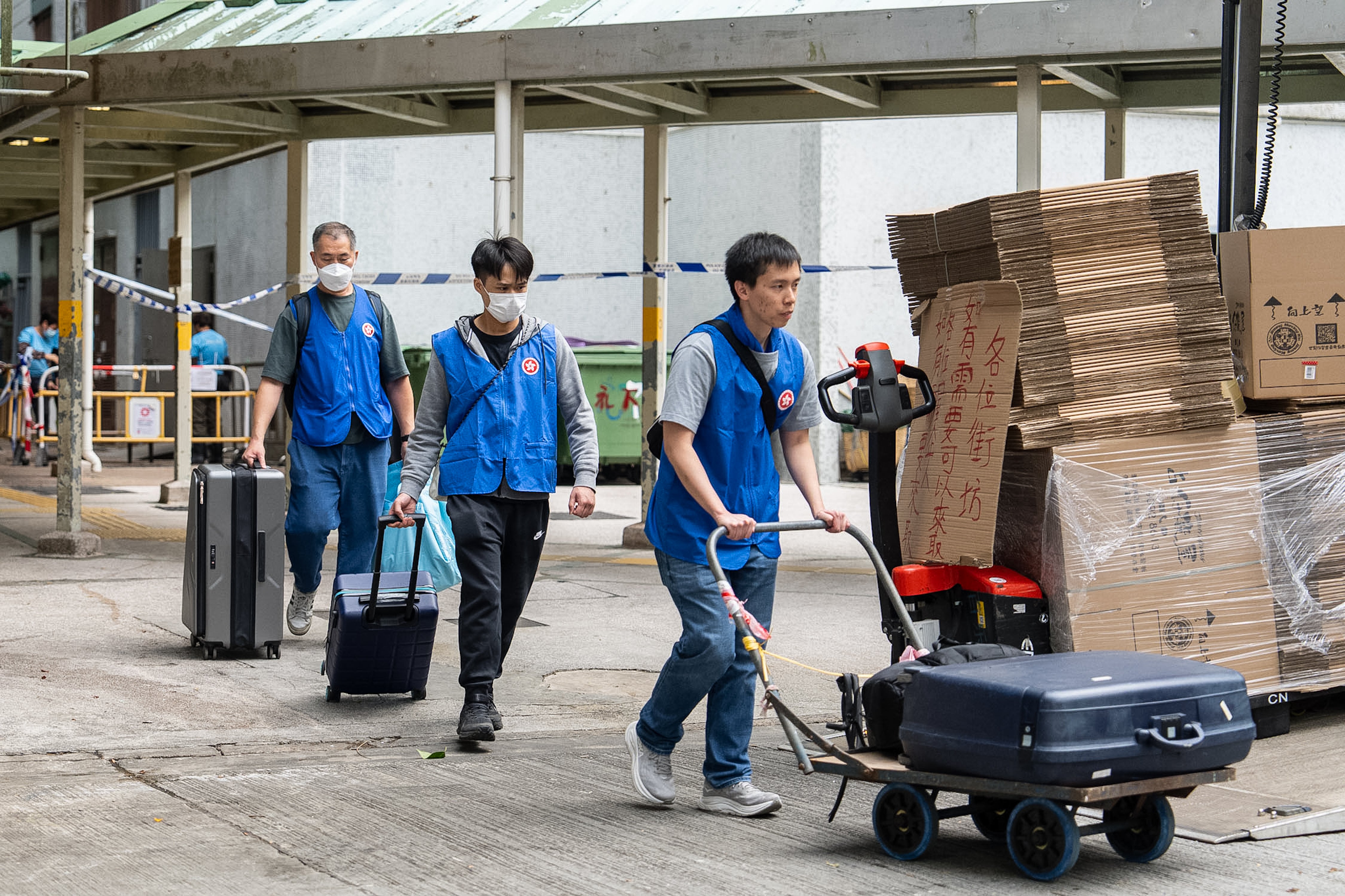Residents are assisted by the Government Quick Response Unit as they return to their homes to collect belongings after the fire at Wang Fuk Court, a residential estate in the Tai Po district of Hong Kong’s New Territories on Wednesday, 3 December 2025