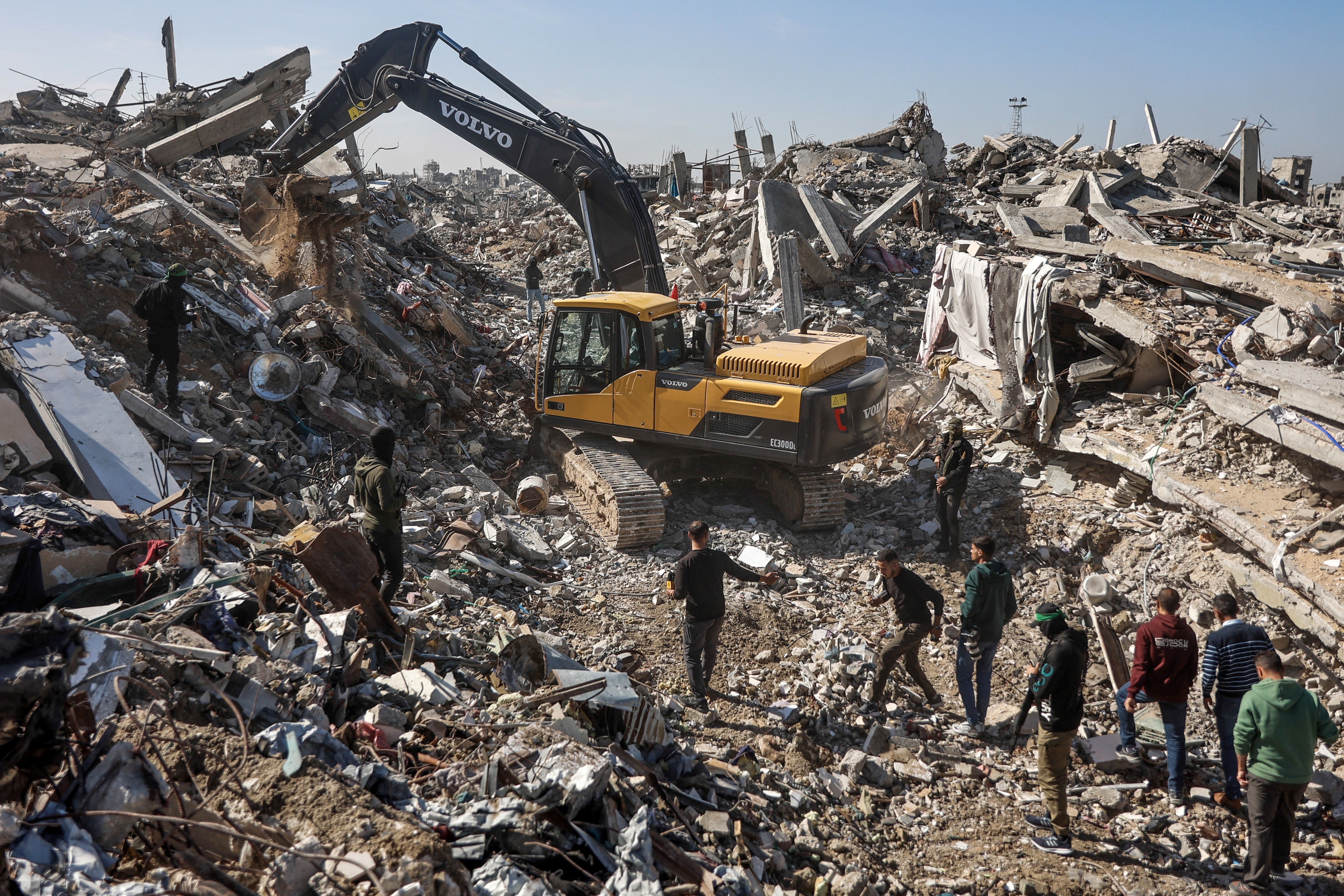 File. Palestinian Hamas militants and Egyptian workers accompanied by members of the International Committee of the Red Cross (ICRC) use a digger as they search for the last two remaining bodies of hostages - an Israeli soldier and a Thai national - under the rubble of the Jabalia refugee camp, in the northern of Gaza Strip on 1 December 2025