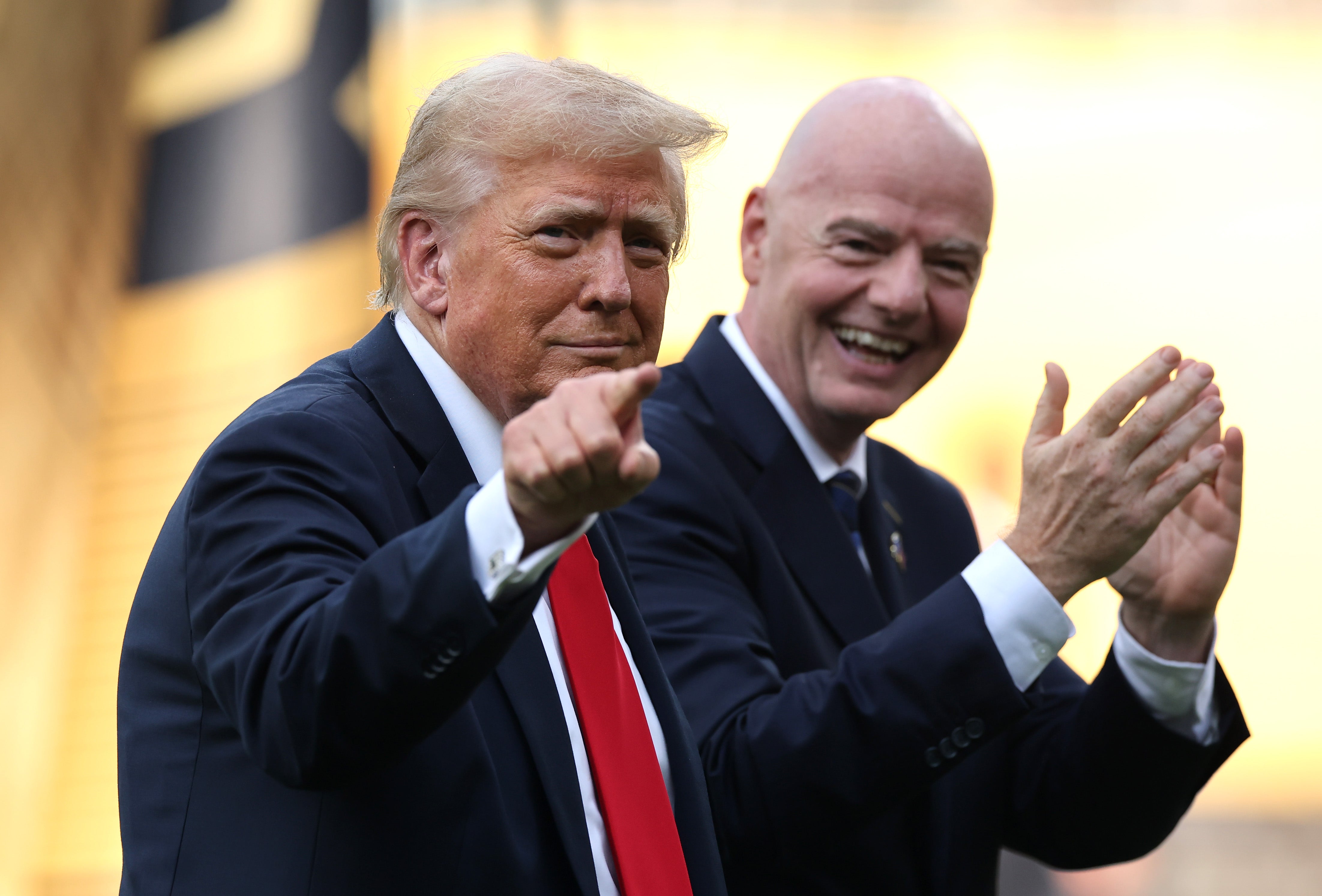 President Donald Trump gestures as Gianni Infantino, president of FIFA, applauds following the FIFA Club World Cup 2025 Final match between Chelsea FC and Paris Saint-Germain at MetLife Stadium on July 13, 2025 in East Rutherford, New Jersey
