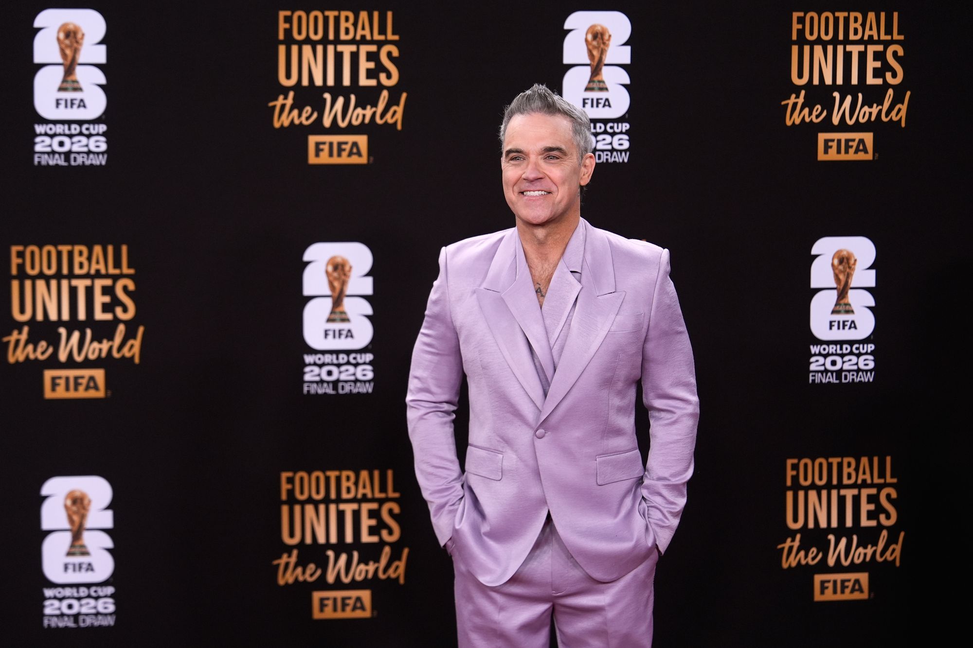 Singer Robbie Williams poses on the red carpet before the draw for the 2026 soccer World Cup at the Kennedy Center in Washington