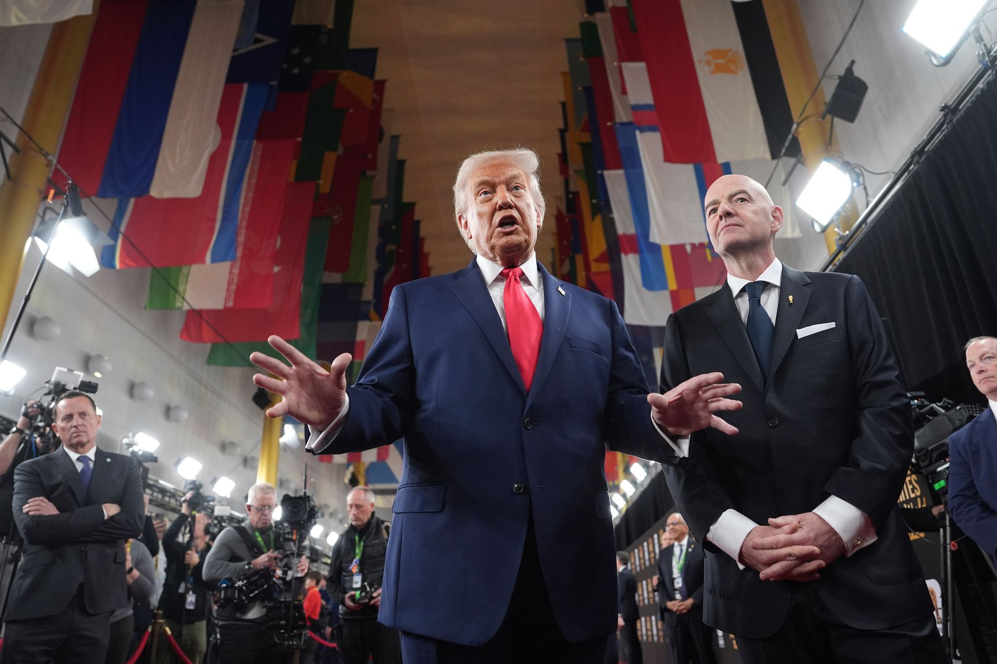 President Donald Trump speaking to members of the media during his arrival with Fifa president Gianni Infantino, right, at the Kennedy Center for the 2026 Fifa World Cup draw