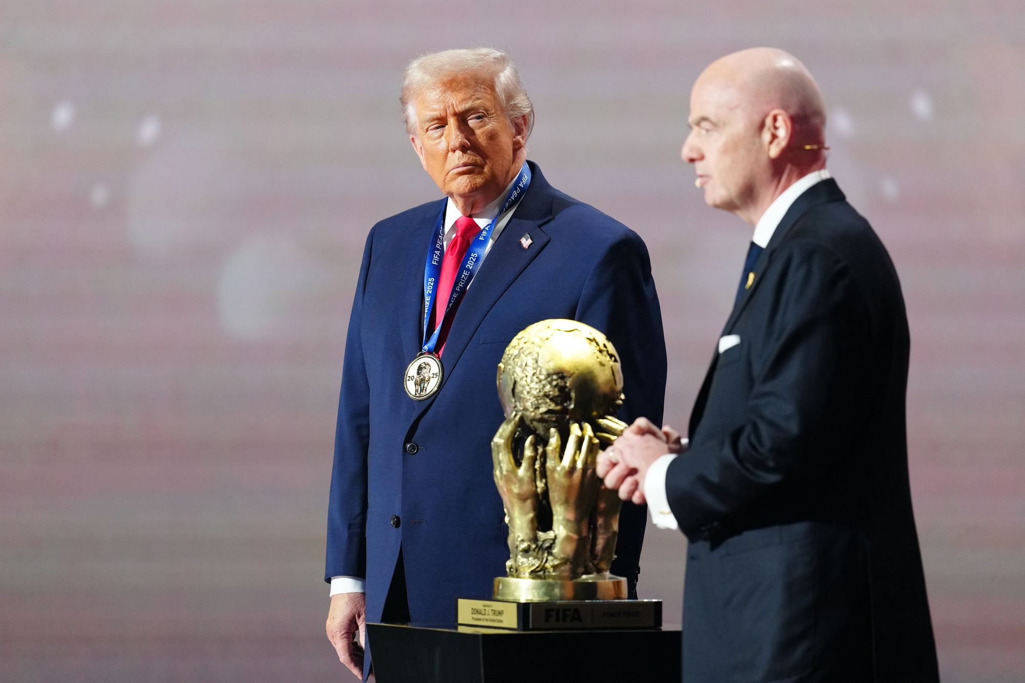 Donald Trump on stage with Gianni Infantino at the World Cup draw