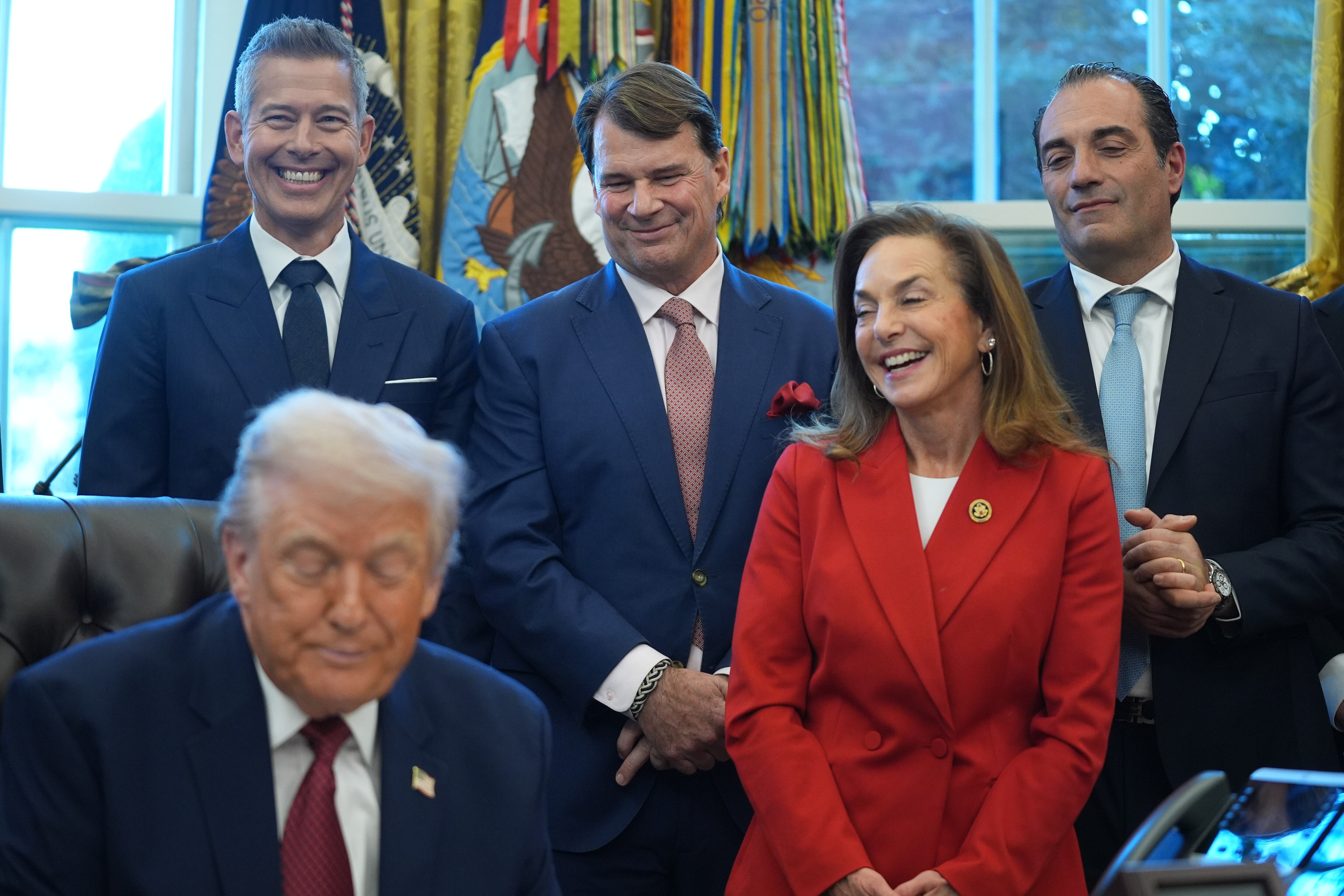 From left: Transportation Secretary Sean Duffy, Ford President Jim Farley, House Republican Conference Chair Lisa McClain and Stellantis CEO Antonio Filosa, listen as President Donald Trump speaks during an event on fuel economy standards in the Oval Office of the White House.