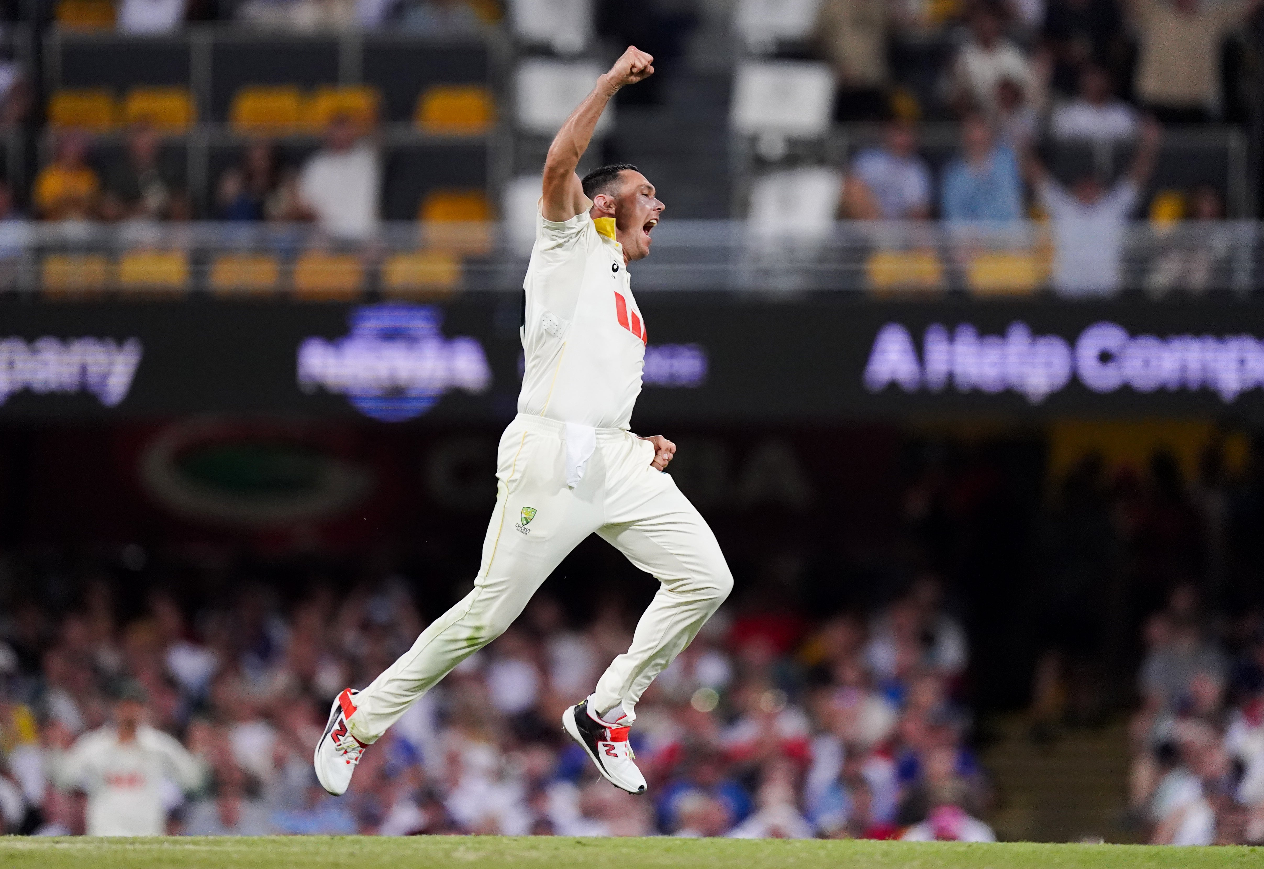 Scott Boland celebrates the wicket of Harry Brook (Robbie Stephenson/PA)